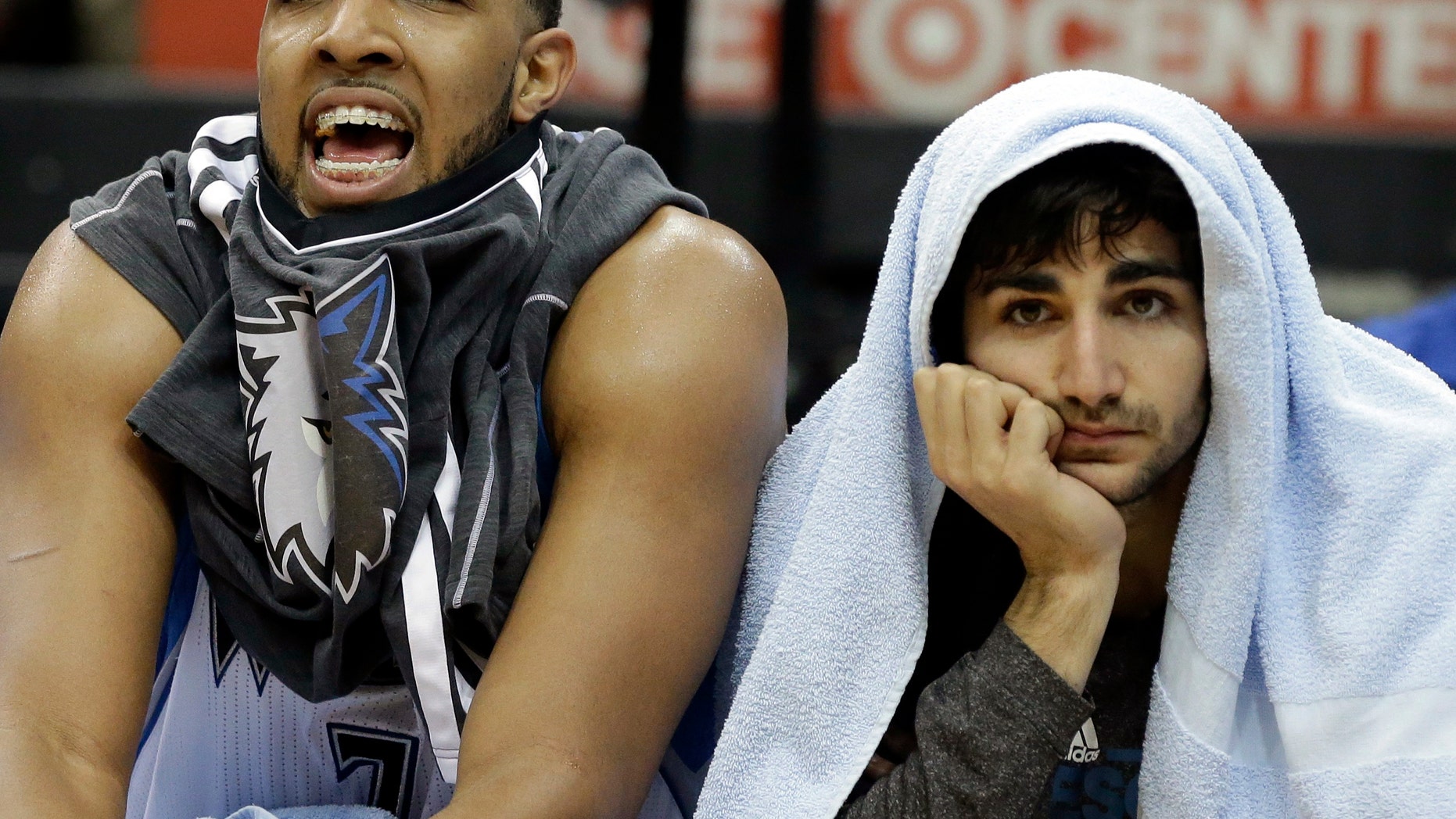 Minnesota Timberwolves' Derrick Williams, left, and Ricky Rubio of Spain watch the closing minutes of their team's last home game of the season and a 96-80 loss to the Utah Jazz in an NBA basketball game Monday, April 15, 2013 in Minneapolis. Williams led the Timberwolves with 18 points. (AP Photo/Jim Mone)
