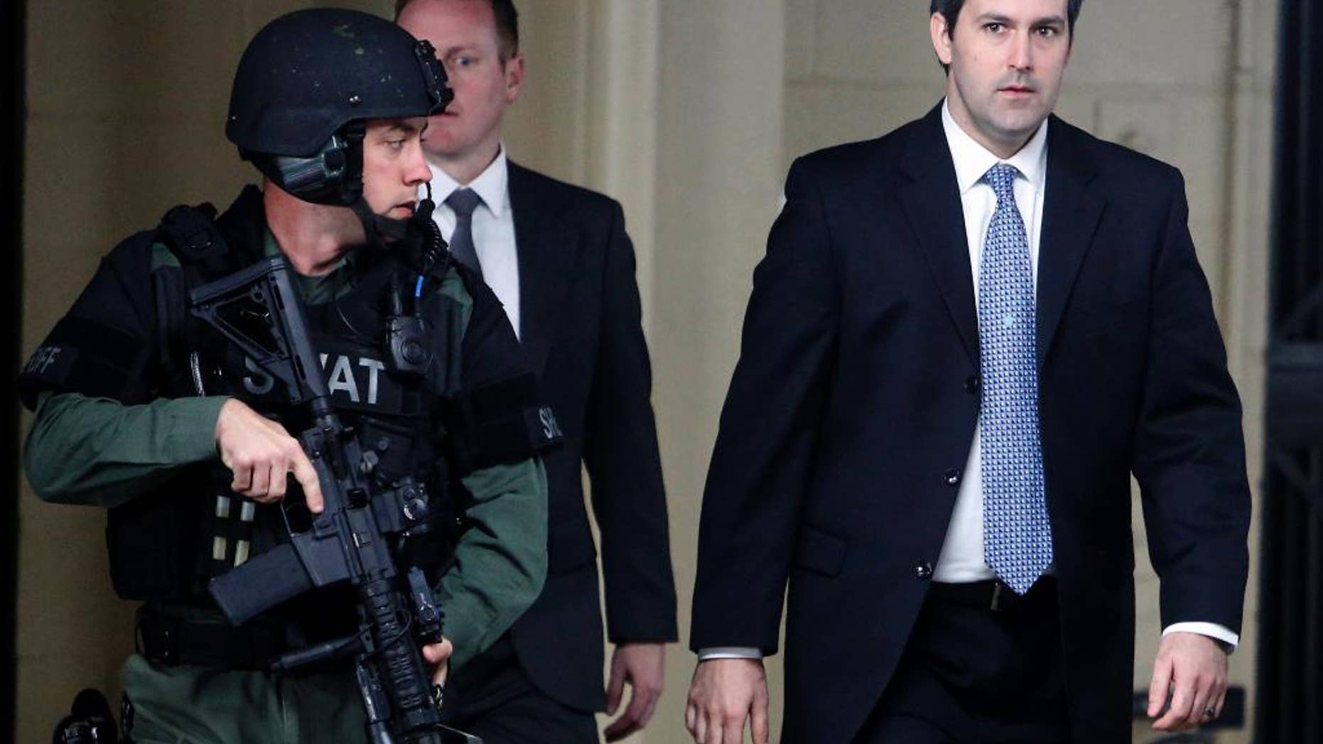 Michael Slager, at right, walks from the Charleston County Courthouse under the protection from the Charleston County Sheriff's Department after a mistrial was declared for his trial Monday Dec. 5, 2016, in Charleston, S.C. Former patrolman, Slager, was charged with murder in the April 4, 2015, shooting death of 50-year-old Walter Scott. (AP Photo/Mic Smith)