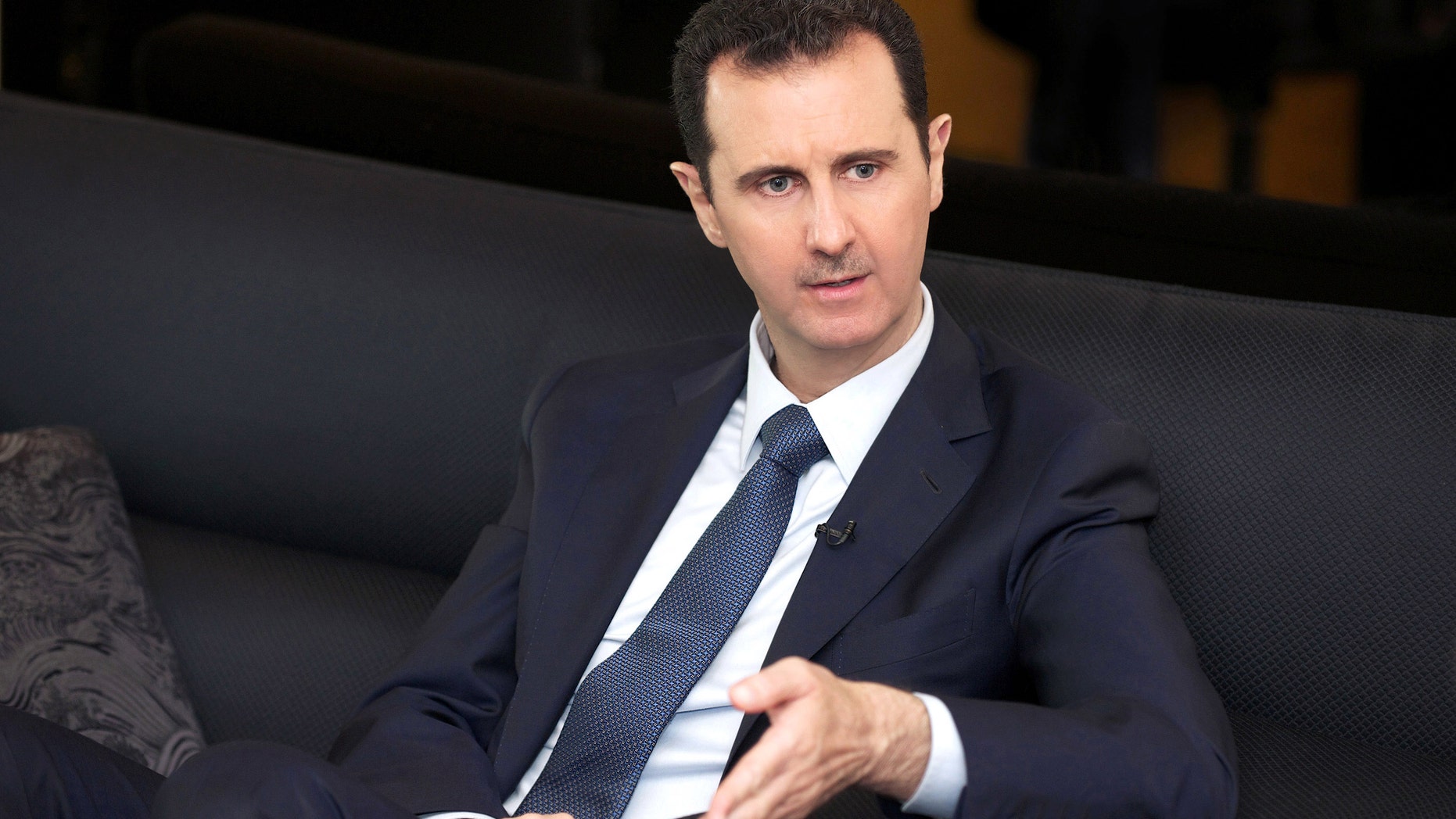 In this photo released by the Syrian official news agency SANA, Syrian President Bashar Assad speaks during an interview with the German magazine Der Spiegel, in Damascus, Syria, Monday, Oct. 7, 2013. Assad has conceded making mistakes and says no side in his country's civil war is entirely free of blame. (AP Photo/SANA)