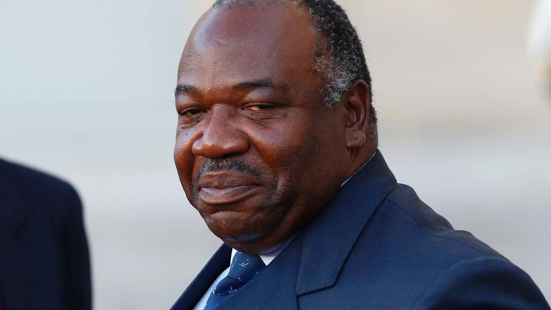 FILE - In this Tuesday, Nov. 10, 2015 file photo, Gabon's President Ali Bongo Ondimba leaves the Elysee Palace after a meeting with French President Francois Hollande as part of preparation of the upcoming COP21 Climate Conference in Paris, France. Gabon's constitutional court upheld incumbent President Bongo's victory in last month's presidential election early Saturday, Sept. 24, 2016, raising fears of continued unrest as the Bongo family extended its political dynasty of nearly half a century in the oil-rich country. (AP Photo/Francois Mori, File)