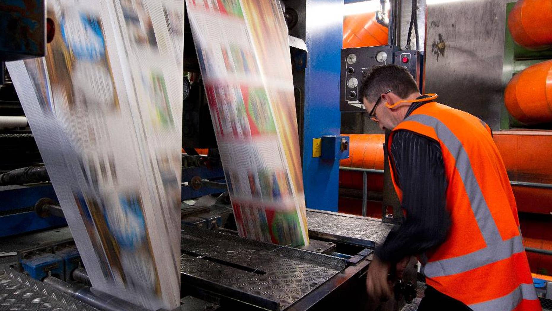 In this Sept. 9, 2012 photo, the first edition of the new compact New Zealand Herald rolls off the press in Auckland, New Zealand. Facing declining revenues and changing reader habits, New Zealand's two main newspaper groups, Fairfax Media and APN News & Media, announced Wednesday, May 11, 2016, they're discussing a merger that could end decades of competition and result in hundreds of job losses. (Sarah Ivey/New Zealand Herald via AP) NEW ZEALAND OUT, AUSTRALIA OUT