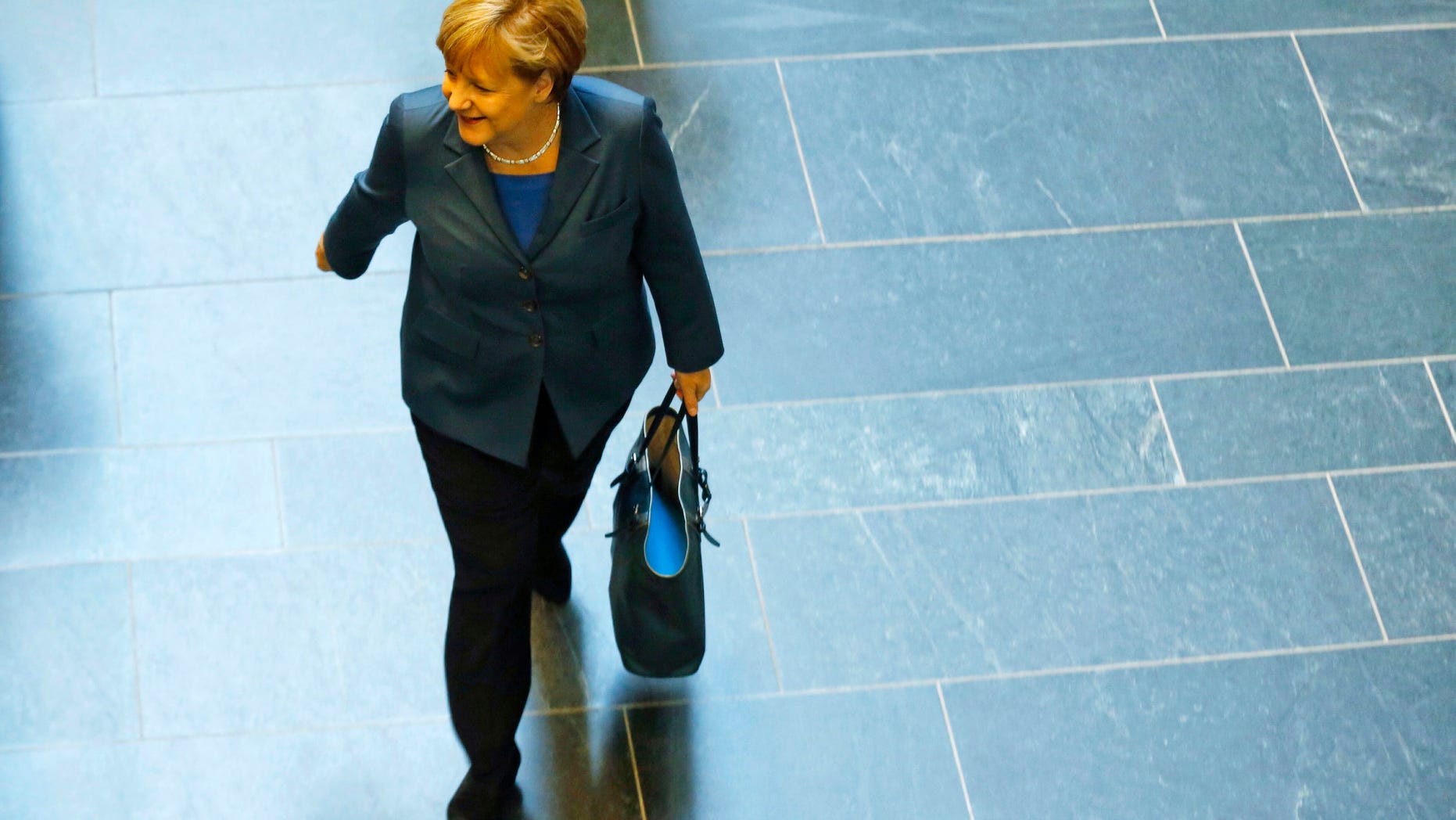 German Chancellor and chairwoman of the Christian Democrats (CDU) Angela Merkel arrives for a meeting with the Christian Democratic parties delegation prior to exploratory talks about an coalition with the Social Democratic Party (SPD) in Berlin Monday, Oct. 14, 2013. Following the national elections on Sept. 22, 2013 Angela Merkel still negotiates about an coalition partner for her third term. (AP Photo/Markus Schreiber)