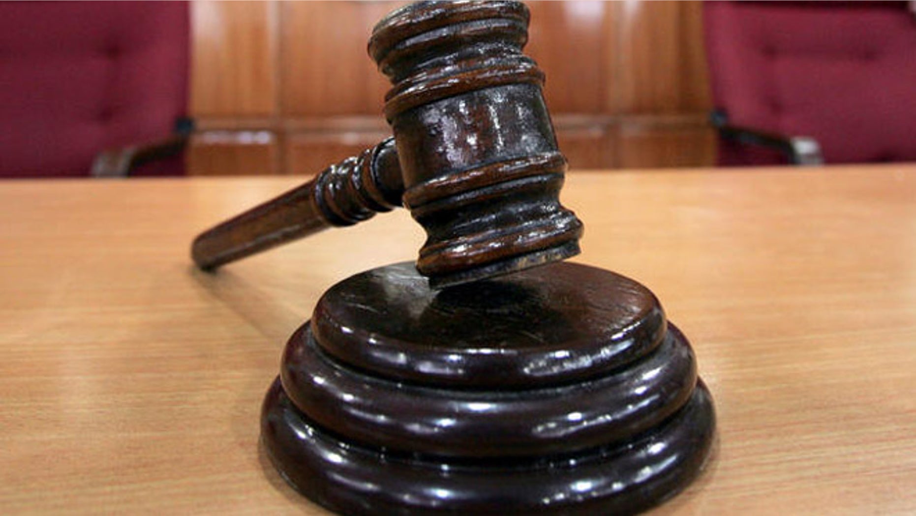 A Sandiganbayan anti-graft court sheriff adjusts chairs inside a courtroom in Quezon city northeast of Manila, Philippines, Tuesday Sept. 11, 2007, where a verdict in ousted Philippine President Joseph Estrada's corruption trial will be announced on Wednesday. (AP Photo/Bullit Marquez)