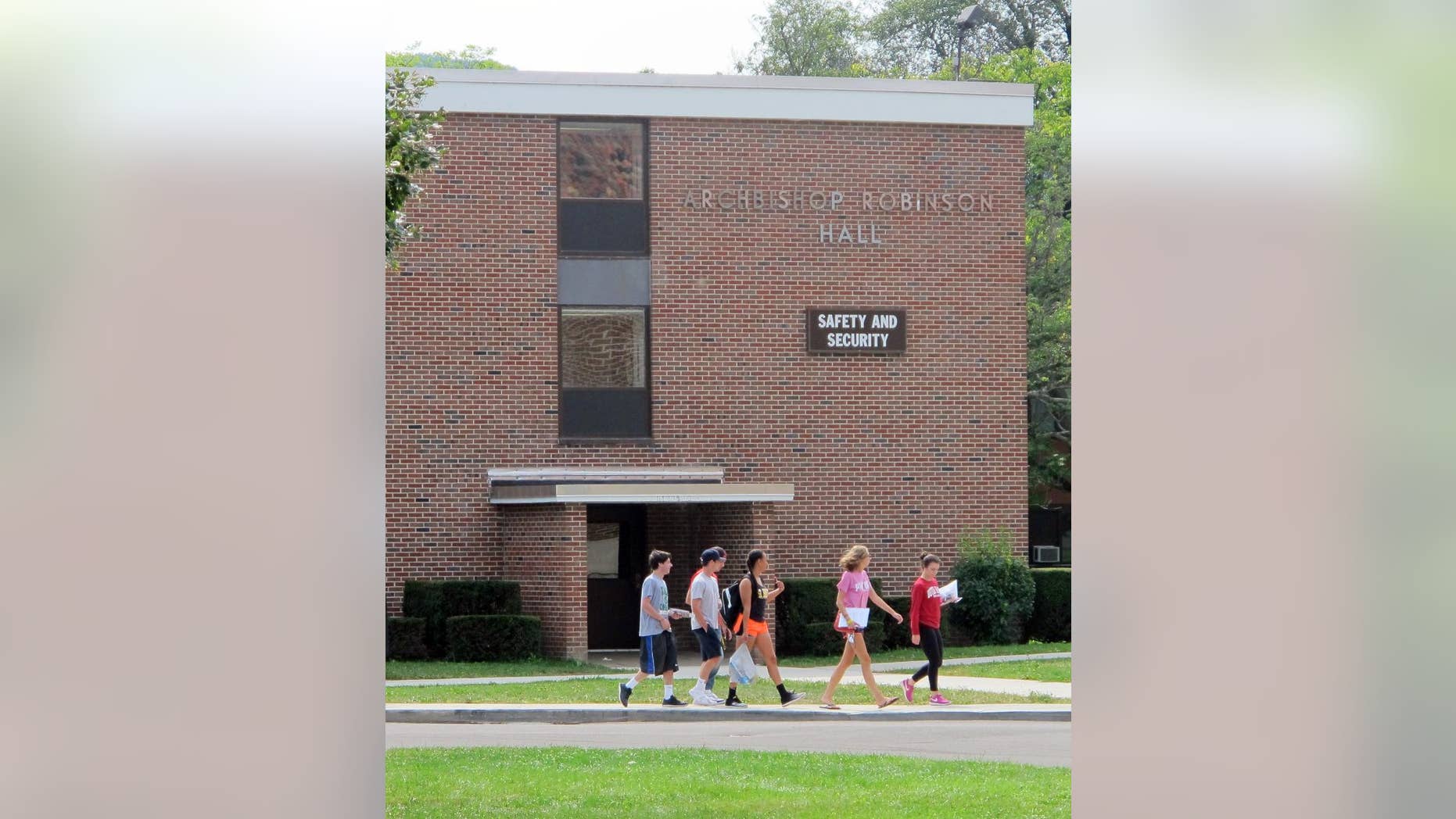 In this Aug. 29, 2015 photo, students walk past the public safety building at St. Bonaventure University in St. Bonaventure, N.Y. Students at New York state's private colleges and universities return to campus with a new, affirmative sexual consent policy to combat campus sexual violence. A bill signed by Gov. Andrew Cuomo over the summer expands on a policy in effect at public colleges which includes a "yes means yes" definition of consent requiring a clear, affirmative agreement between partners. In July, New York became the second state, after California, to write the affirmative consent standard into law for campuses. (AP Photo/Carolyn Thompson)