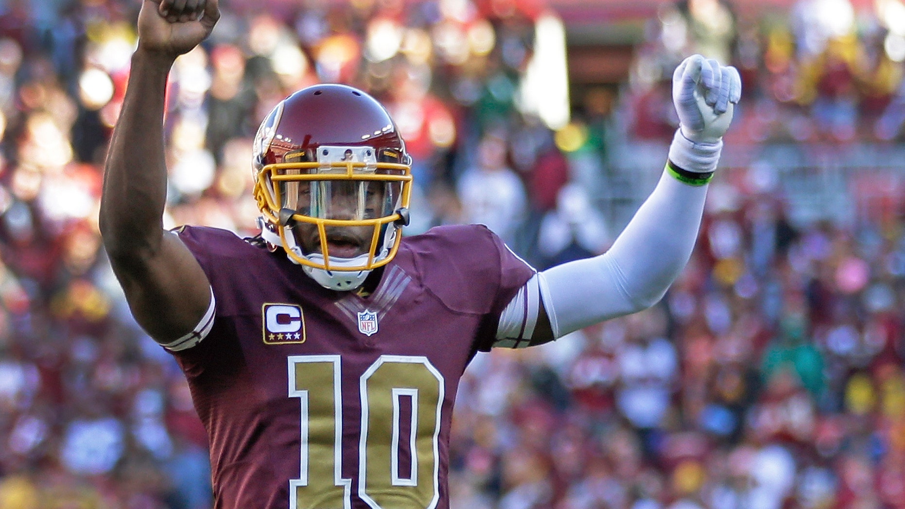 Washington Redskins quarterback Robert Griffin III celebrates a touchdown by fullback Darrel Young during the second half of a NFL football game against San Diego Chargers in Landover, Md., Sunday, Nov. 3, 2013. (AP Photo/Patrick Semansky)