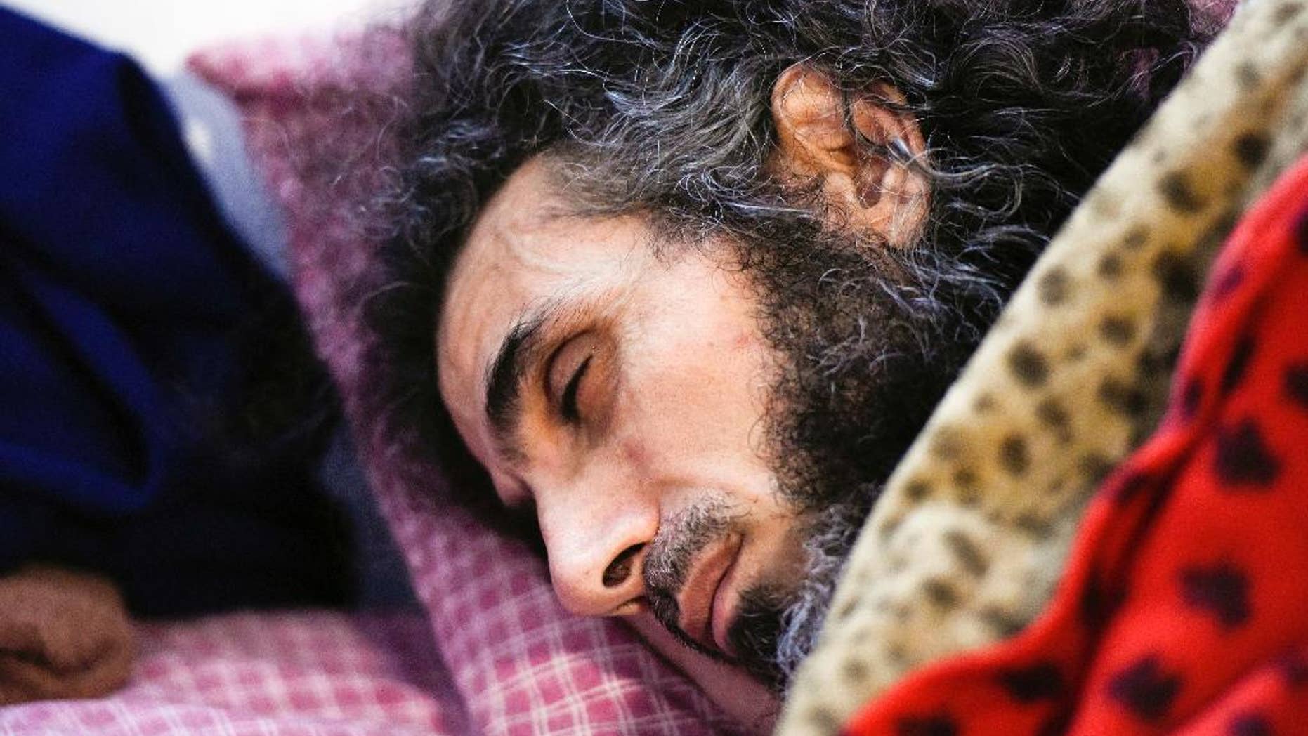 FILE - In this Sept. 9, 2016 file photo, Syrian native Abu Wa'el Dhiab rests in bed while conversing with his family via a laptop, in his apartment in Montevideo, Uruguay. Uruguay's president said on Wednesday, Sept. 21, that Dhiab demands exceed his government's capacity to deliver. (AP Photo/Matilde Campodonico, File)