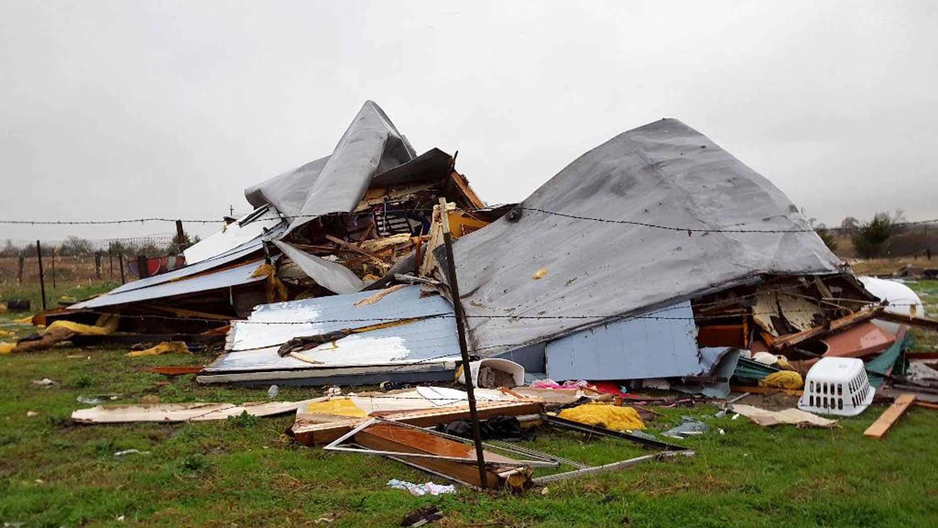 This Sunday, Dec. 27, 2015 photo shows damage to the home where Daniel and Zuleyma Santillano lived with their newborn and three older children in Blue Ridge, Texas, north of Dallas. The Santillano's newborn was killed when the home was destroyed by a tornado Saturday night. (AP Photo/Reese Dunklin)