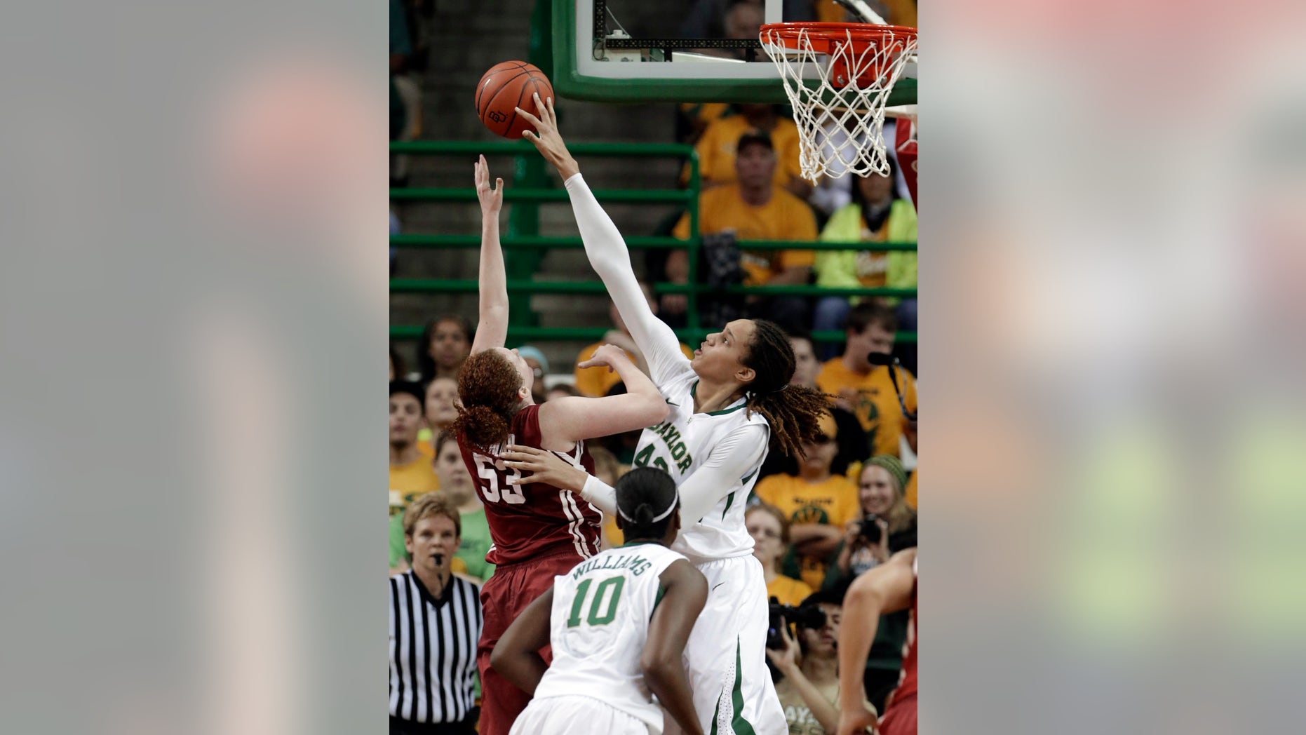 FILE - In this Jan. 26, 2013 file photo, Baylor's Brittney Griner (42) blocks the shot of Oklahoma's Joanna McFarland (53) during the second half of an NCAA college basketball game in Waco Texas. Griner was selected to the 2012-13 AP Women's All-America team, Tuesday, April 2, 2013. (AP Photo/LM Otero, FIle)