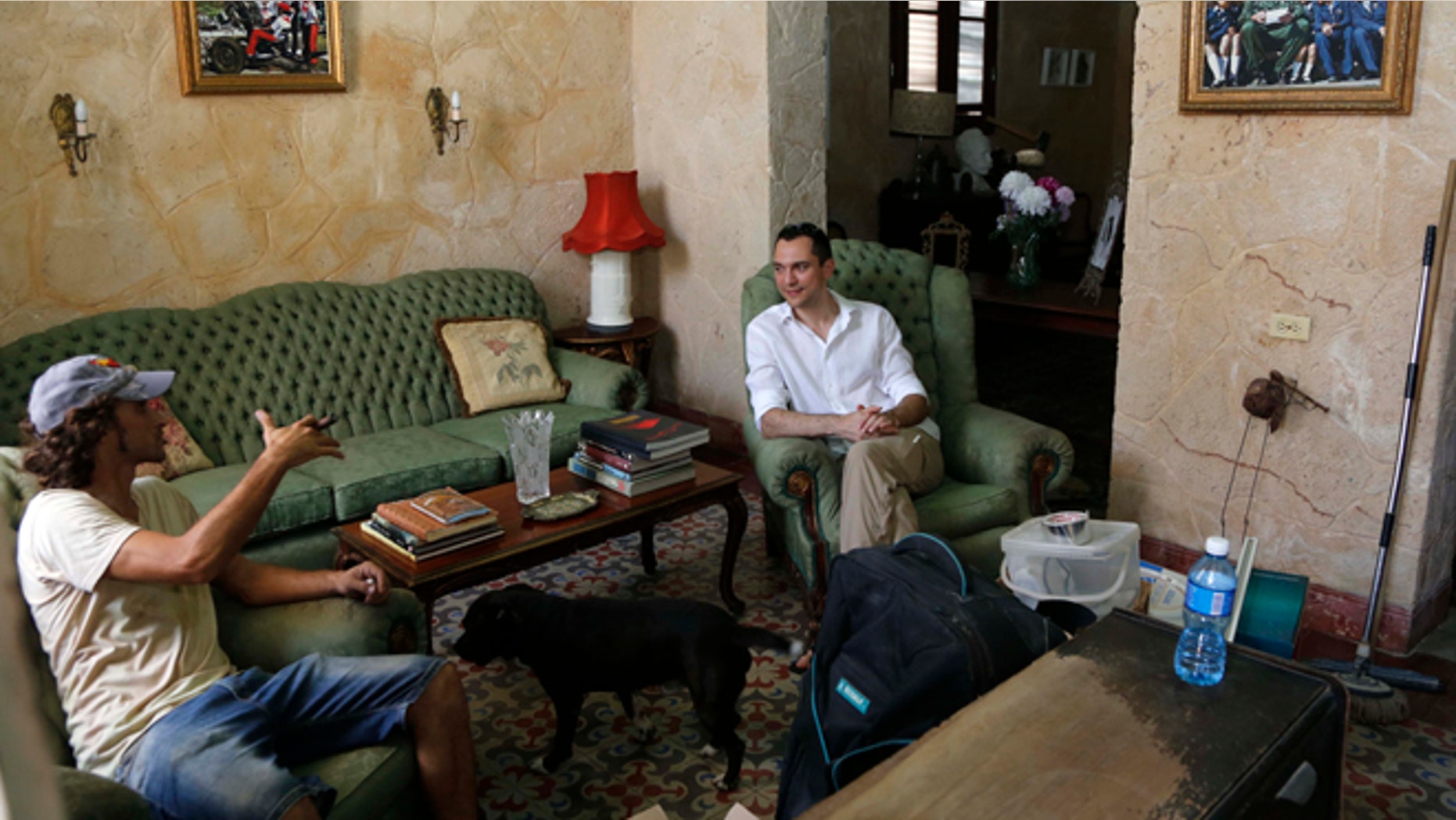 Co-founder of AirBnb Nathan Blecharczyk, right, visits with guesthouse owner Armando Usain in Havana, Cuba, Wednesday, June 24, 2015. AirBnb has added more than 2,000 listings in Cuba, which has long had an extensive network of legal private home for rent to travelers. (AP Photo/Desmond Boylan)