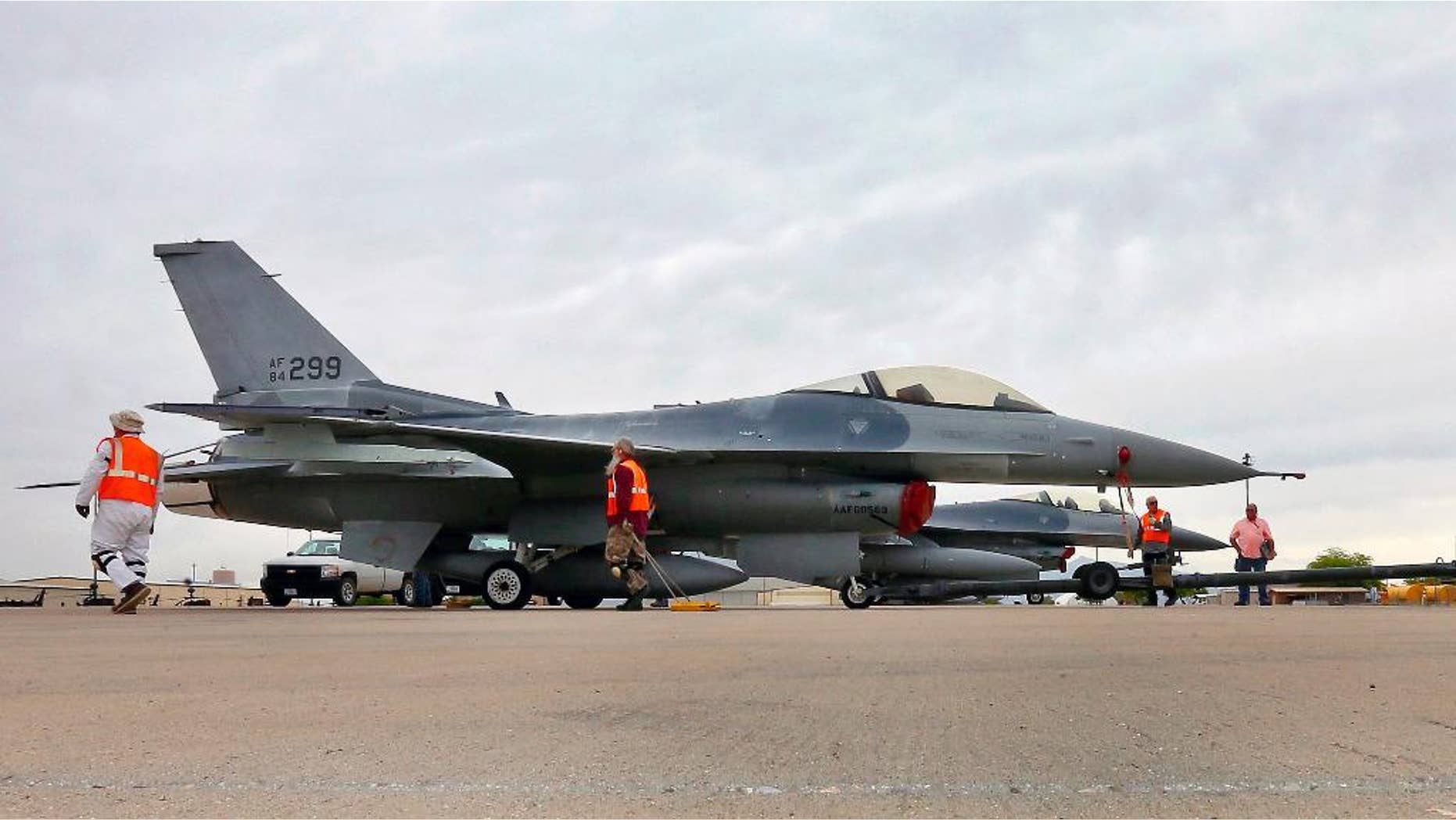 FILE - In this May 15, 2015, file photo, a boneyard crew tows an F-16 Fighting Falcon aircraft prior to the preservation process after its arrival at the 309th Aerospace Maintenance and Regeneration Group at Davis-Monthan Air Force Base in Tucson, Ariz. Military officials confirm a single F-16 Fighting Falcon aircraft crashed Wednesday night, June 24, 2015, about 5 miles east of Douglas Municipal Airport. The pilot with the 162nd Wing Arizona Air National Guard was the only person on board during the night training mission, according to an Arizona Air National Guard statement. The pilot's identity and condition is unknown at this time. (AP Photo/Matt York, File)