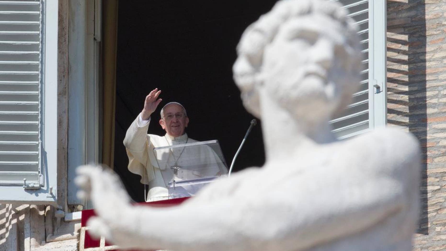 Pope Francis delivers his blessing during the Angelus noon prayer he celebrated from the window of his studio overlooking St. Peter's Square, at the Vatican, Sunday, March 9, 2014. (AP Photo/Andrew Medichini)