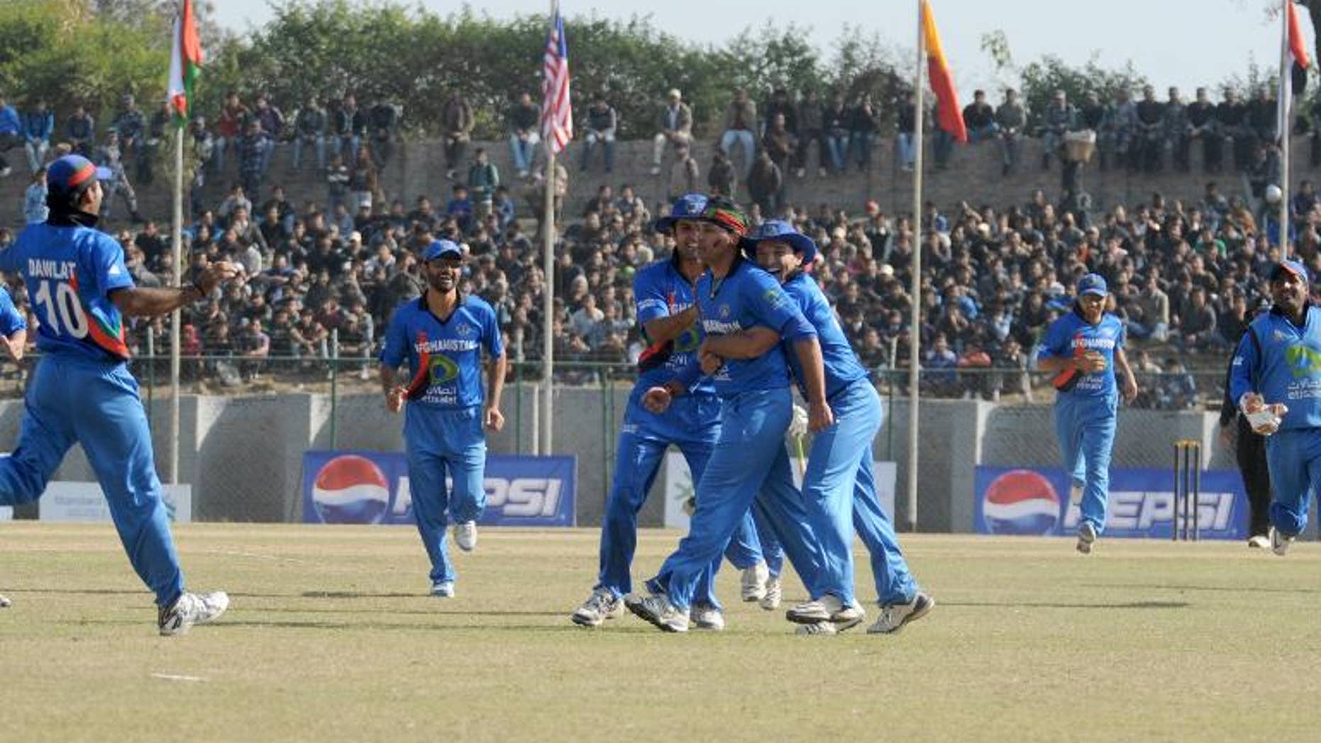Afghani player Hamid Hassan (centre) celebrates with teammates after taking wicket of Hong Kong player Baber Hayat (unseen) during the Asian Cricket Council (ACC) Twenty20 cup final in Kathmandu on December 11, 2011