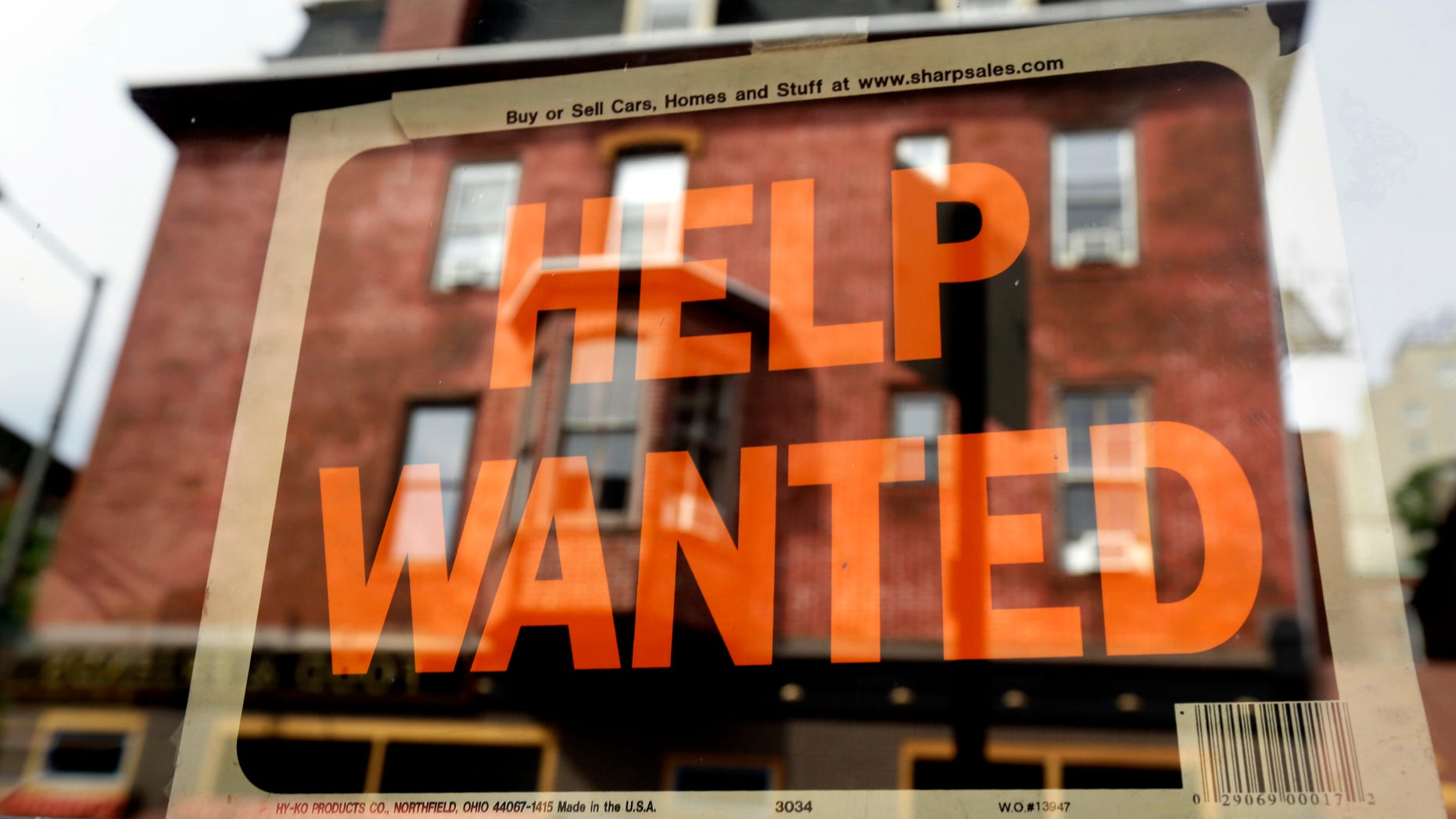 FILE - In this Aug. 19, 2013 file photo, a Philadelphia business displays a help wanted sign in its storefront. The Labor Department releases weekly jobless claims on Thursday, April 2, 2015. (AP Photo/Matt Rourke, File)