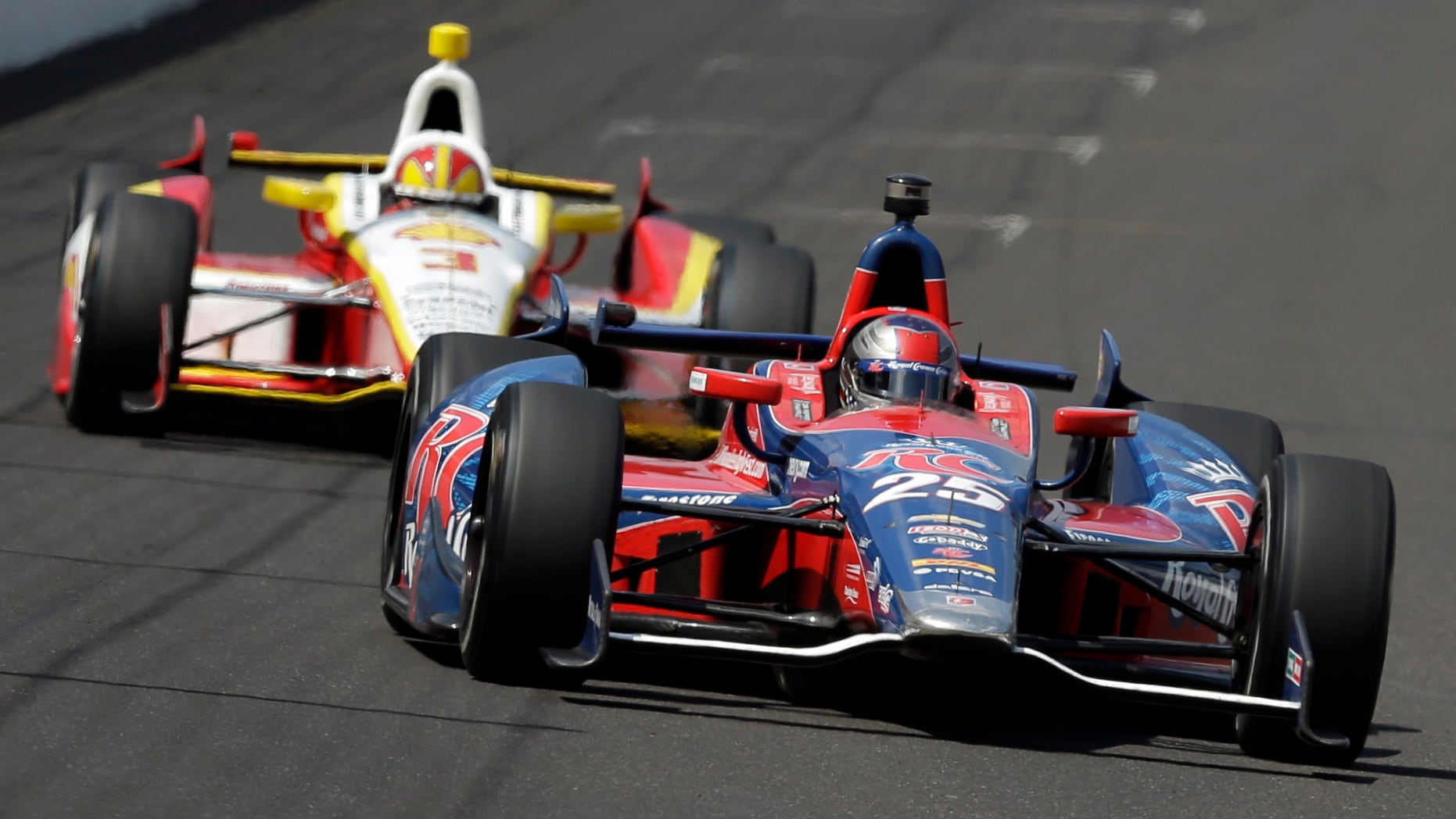 In this May 19, 2013 photo, Marco Andretti, leads Helio Castroneves, of Brazil, into the first turn on the second day of qualifications for the Indianapolis 500 auto race at the Indianapolis Motor Speedway in Indianapolis. Graham Rahal and Andretti have all the ingredients the IndyCar Series has been craving. They have famous family names, have reached Victory Lane and seem to enjoy playing up their growing rivalry. (AP Photo/Darron Cummings)
