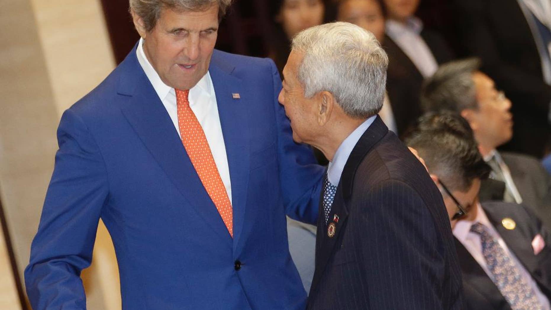 U.S. Secretary of State John Kerry, left, talks to Philippine Foreign Secretary Perfecto Yasay Jr. before the Association of Southeast Asian Nations (ASEAN)-U.S. Foreign Ministers Meeting in Vientiane, Laos, Monday, July 25, 2016. Southeast Asia's main grouping made a last-ditch attempt to reach a consensus on countering China's territorial expansion in the South China Sea, but their deadlock appeared far from being resolved as minutes ticked by before a critical meeting with the Chinese foreign minister Monday. (AP Photo/Sakchai Lalit)