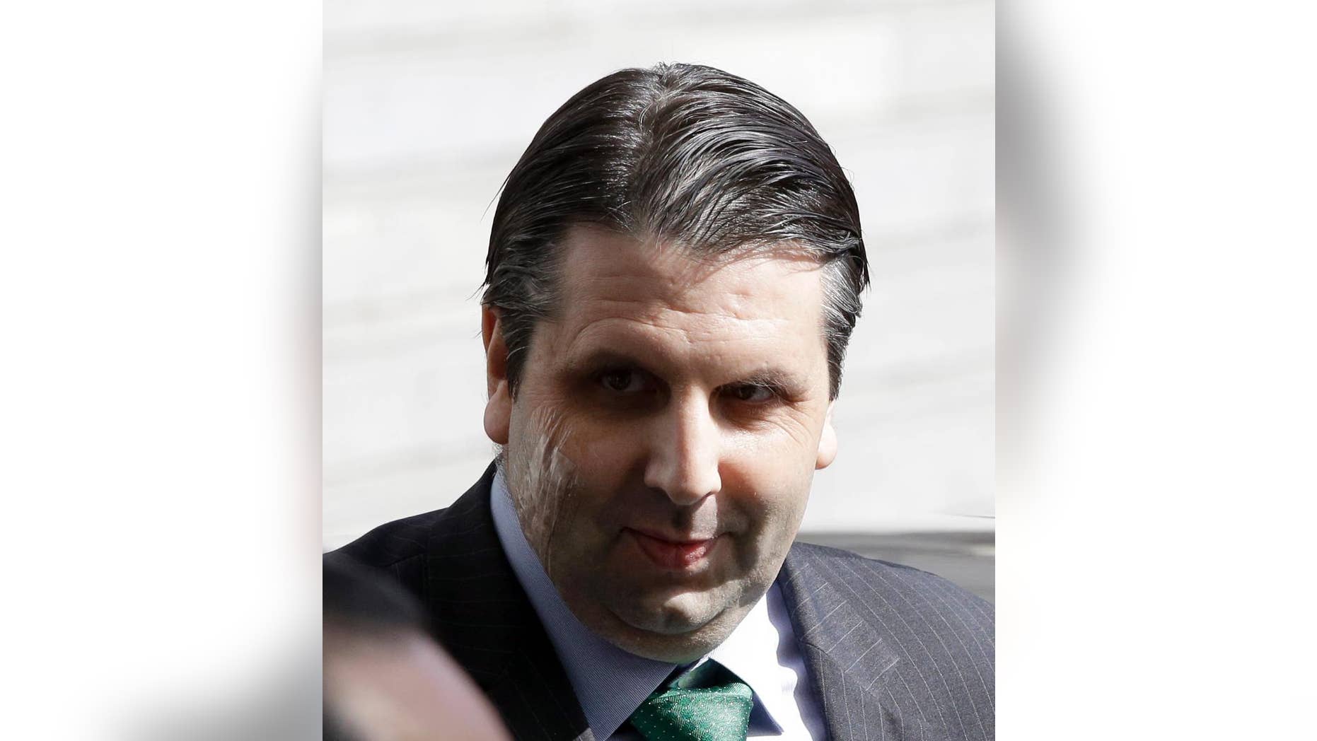 In this March 10, 2015, injured U.S. Ambassador to South Korea Mark Lippert leaves after being discharged from Seoul's Severance Hospital in Seoul, South Korea. South Korean police said Friday that they had arrested a 33-year-old jobless man for allegedly making an online threat to kill the U.S. ambassador in Seoul. The man allegedly left an English message vowing to "kill" Mark Lippert with "nuclear poisoning" on the website of the White House on July 8, police said in a statement. (AP Photo/Lee Jin-man)