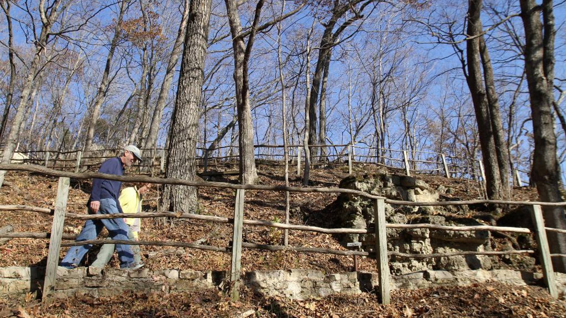 FILE - In this Nov. 8, 2010, file photo, pedestrians hike one of the trails at Effigy Mounds National Monument in Harpers Ferry, Iowa. Thomas Munson, the former superintendent of the monument, is scheduled to be sentenced Friday, July 8, 2016, in Cedar Rapids for stealing the remains of Native Americans who died hundreds of years ago. He's admitted to stealing a collection of ancient bones in 1990 and stashing them in his garage for two decades. (Justin Hayworth/The Des Moines Register via AP, File)
