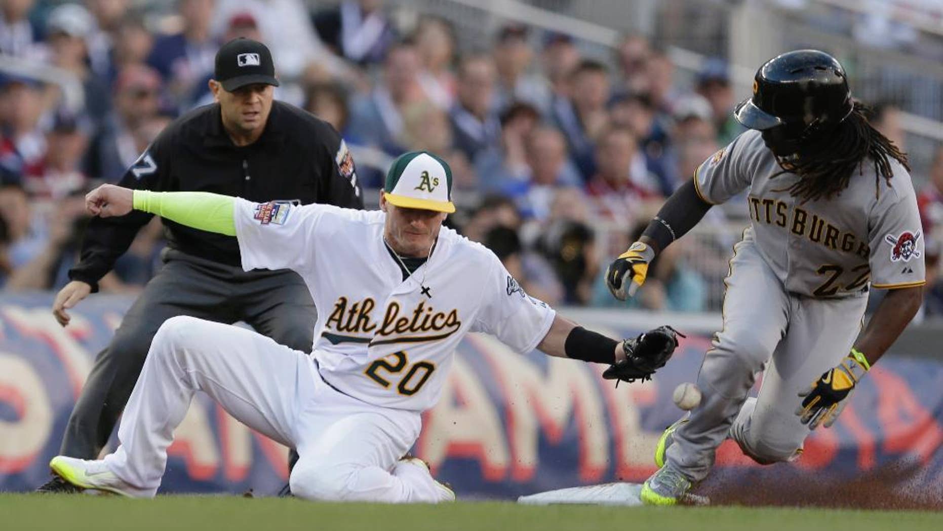 National League outfielder Andrew McCutchen, of the Pittsburgh Pirates, steals third base as American League Josh Donaldson, of the Oakland Athletics, tries to make the tag during the first inning of the MLB All-Star baseball game, Tuesday, July 15, 2014, in Minneapolis. (AP Photo/Jeff Roberson)