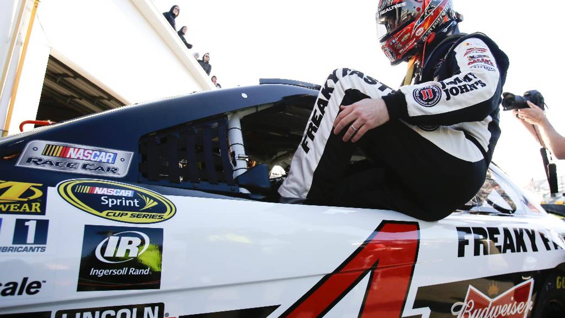 Kevin Harvick climbs in his car during practice for the NASCAR Sprint Cup Series auto race at Daytona International Speedway, Friday, Feb. 13, 2015, in Daytona Beach, Fla. (AP Photo/John Raoux)