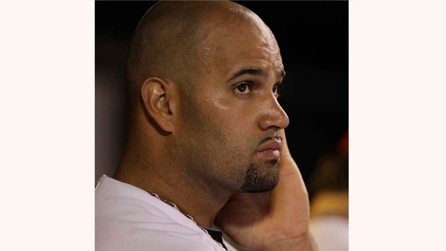 FILE - In this Aug. 17, 2010 file photo, St. Louis Cardinals first baseman Albert Pujols looks up toward the scoreboard as he stands in the dugout during the seventh inning of a baseball game against the Milwaukee Brewers in St. Louis. St. Louis manager Tony La Russa is reiterating that he believes three-time NL MVP Pujols is being pressured by the players' union during contract negotiations. With a noon Eastern deadline for a new deal looming, Pujols was not at camp with the Cardinals on Wednesday, Feb. 16, 2011. (AP Photo/Jeff Roberson, File)