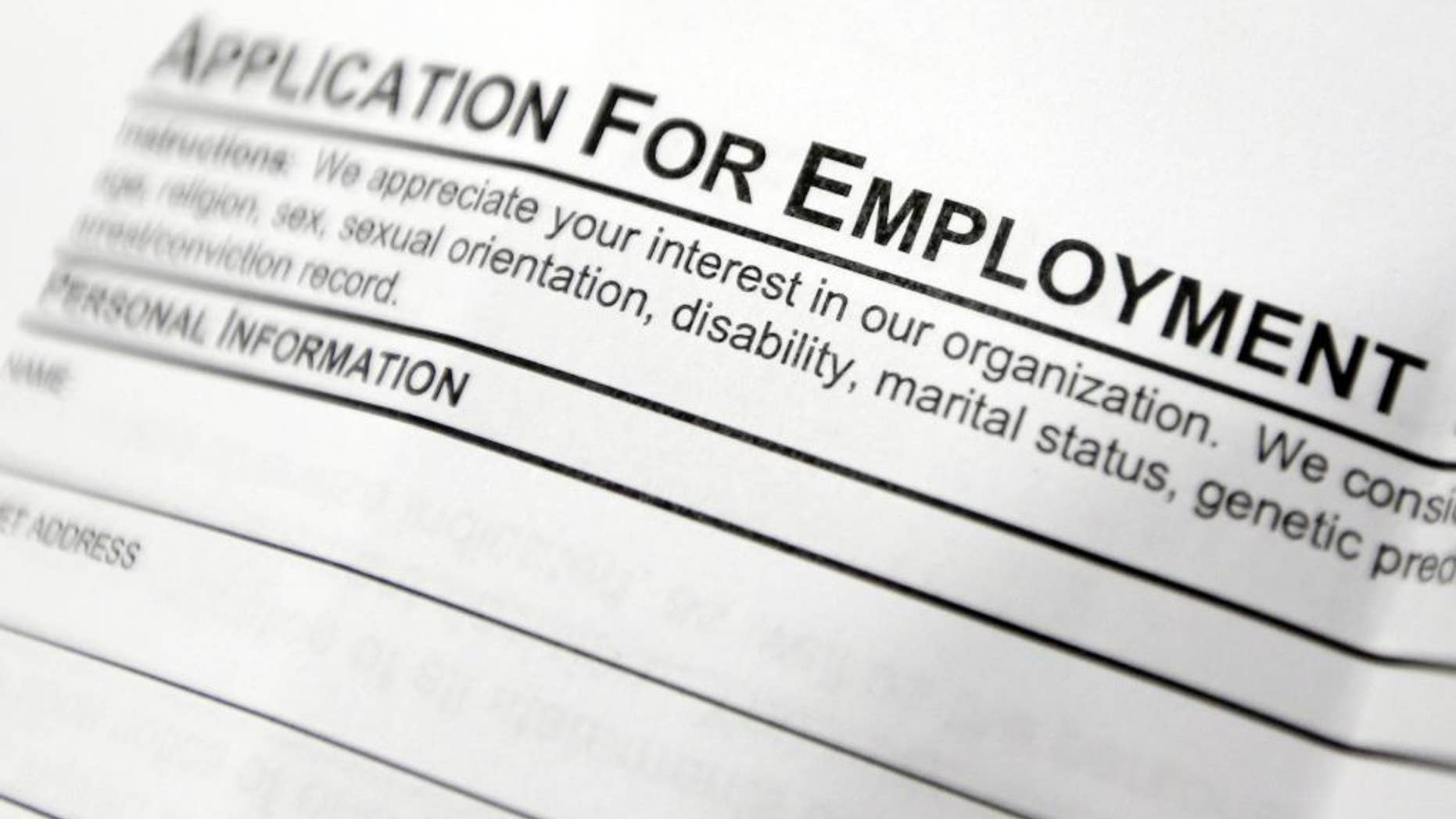 FILE - This April 22, 2014, file photo shows an employment application form on a table during a job fair at Columbia-Greene Community College in Hudson, N.Y. The Labor Department releases its weekly report on applications for unemployment benefits on Thursday, Sept. 25, 2014. (AP Photo/Mike Groll, File)