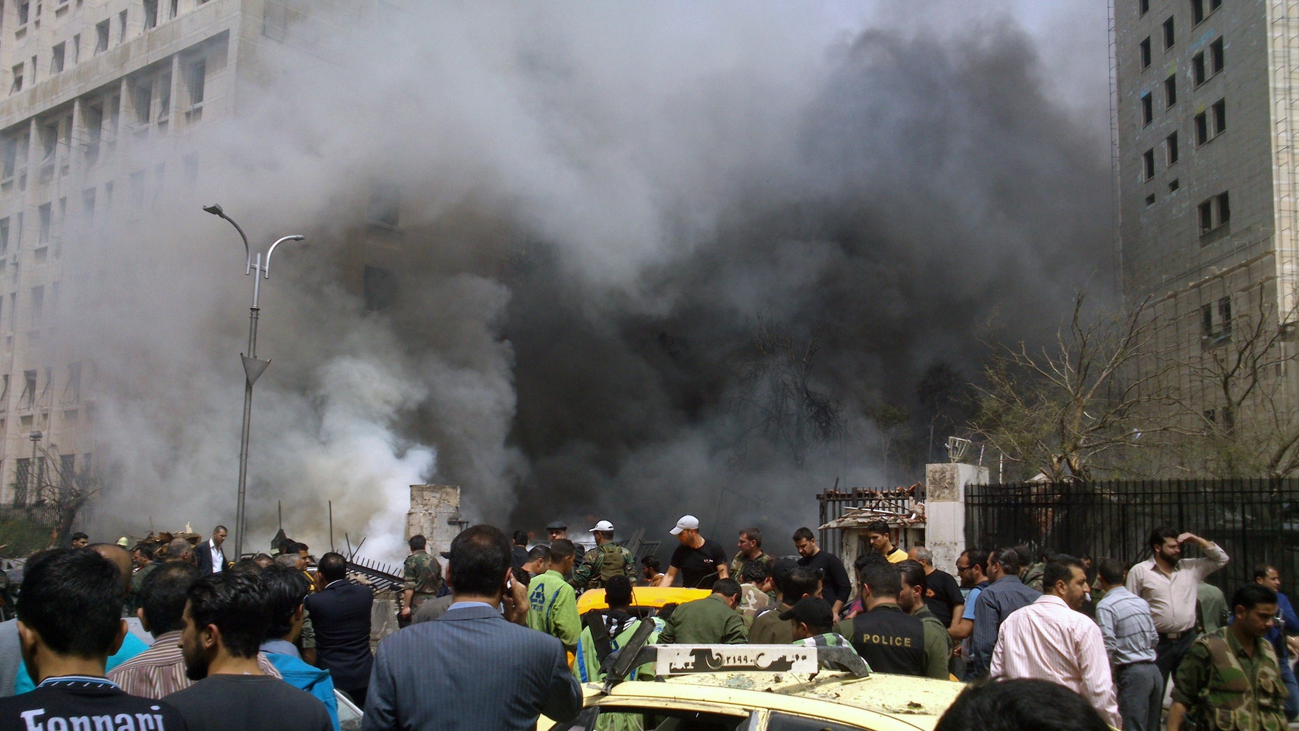 April. 8, 2013: This photo released by the Syrian official news agency SANA, shows smoke rising from burned cars after a huge explosion shook the Sabaa Bahrat Square, one of the capital's biggest roundabouts, in Damascus, Syria. A car bomb rocked a busy residential and commercial district in central Damascus on Monday, killing more than a dozen with many more injured and sending a huge cloud of black smoke billowing over the capital’s skyline, Syrian state-run media said.