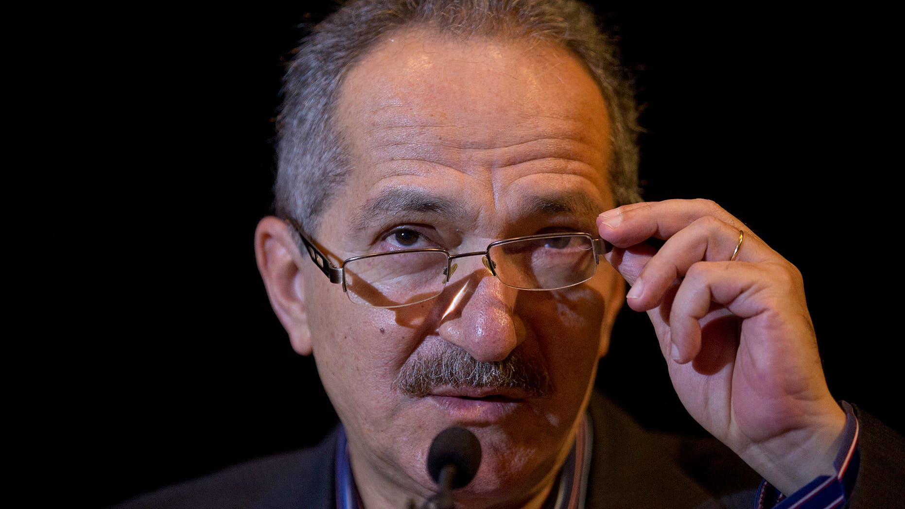 Brazil's Sports Minister Aldo Rebelo adjusts his glasses during a news conference in Sao Paulo, Brazil, Monday, Oct. 28, 2013. Rebelo is not expecting waves of protests during the World Cup next year, saying the Brazilian people will be more worried about celebrating the tournament than complaining of its cost. (AP Photo/Andre Penner)