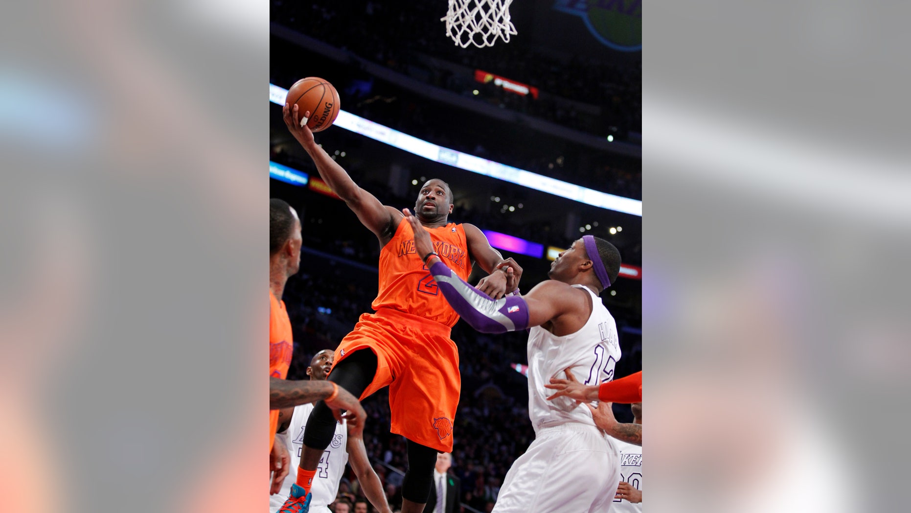 New York Knicks guard Raymond Felton (2) shoots against Los Angeles Lakers center Dwight Howard, right, during the second half of their NBA basketball game in Los Angeles, Tuesday, Dec. 25, 2012. The Lakers won 100-94. (AP Photo/Alex Gallardo)
