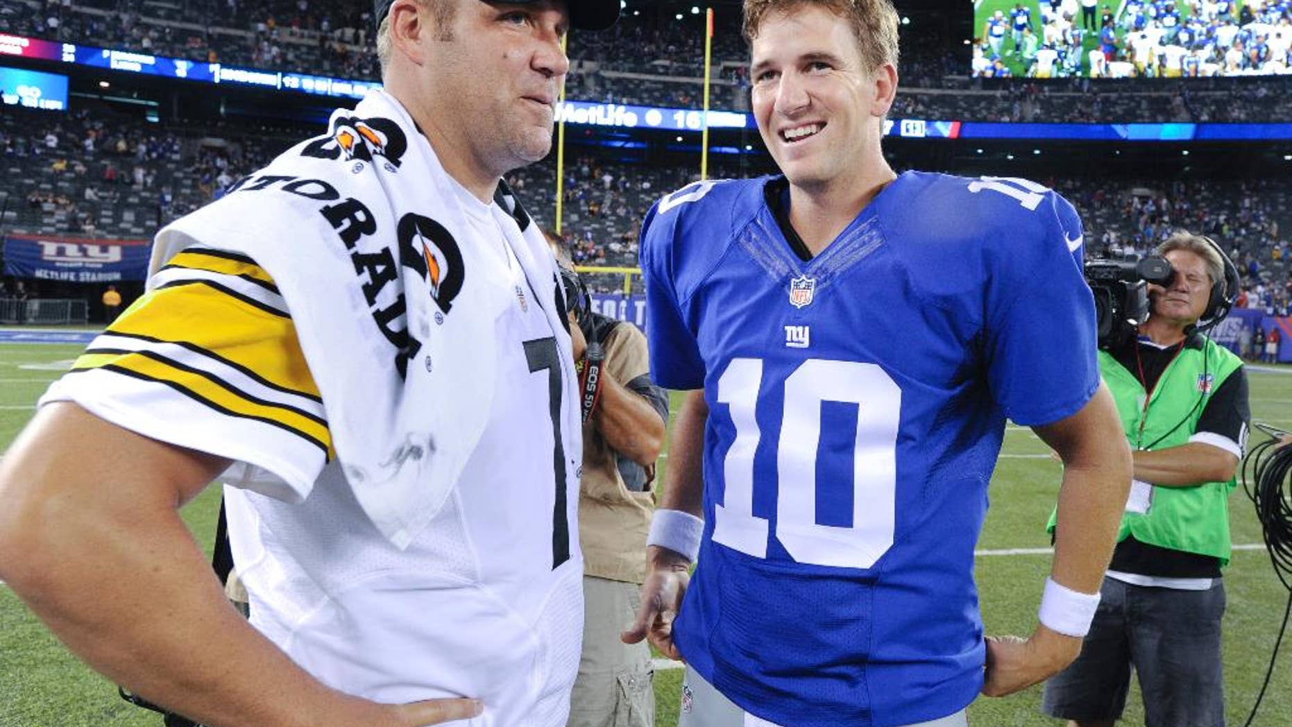 Pittsburgh Steelers quarterback Ben Roethlisberger (7) and New York Giants quarterback Eli Manning (10) talk after the Giants beat the Steelers 20-16 in a preseason NFL football game, Sunday, Aug. 10, 2014, in East Rutherford, N.J. (AP Photo/Bill Kostroun)