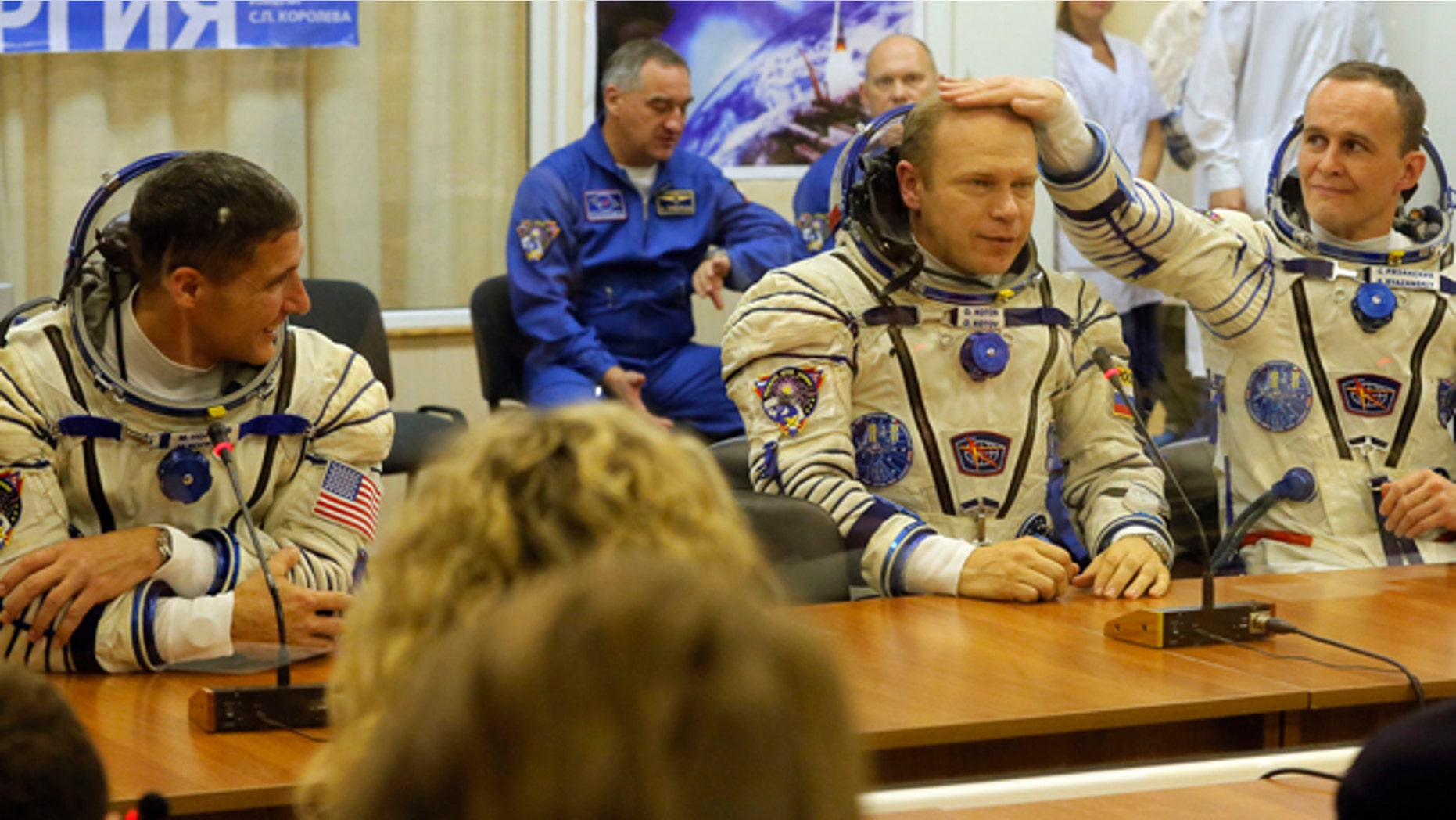 Sept. 26, 2013: U.S. astronaut Michael Hopkins, Russian cosmonauts Oleg Kotov and Sergey Ryazanskiy, crew members of the mission to the International Space Station, ISS, speak with their familys prior the launch of Soyuz-FG rocket.