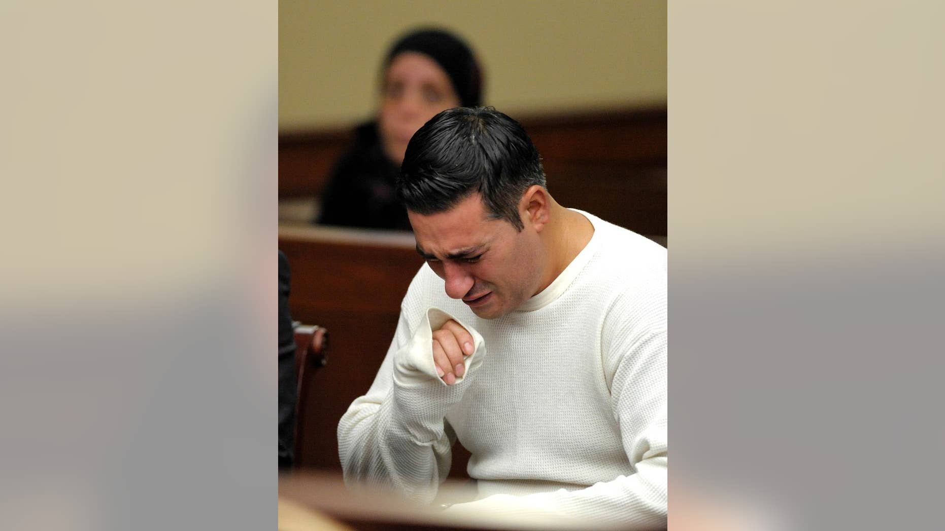 Defendant Bassel Saad sobs during a probable-cause hearing Wednesday afternoon, July 30, 2014, in Livonia, Mich. Saad is charged with second-degree murder in the death of soccer referee John Bieniewicz. (AP Photo/The Detroit News, Todd McInturf)
