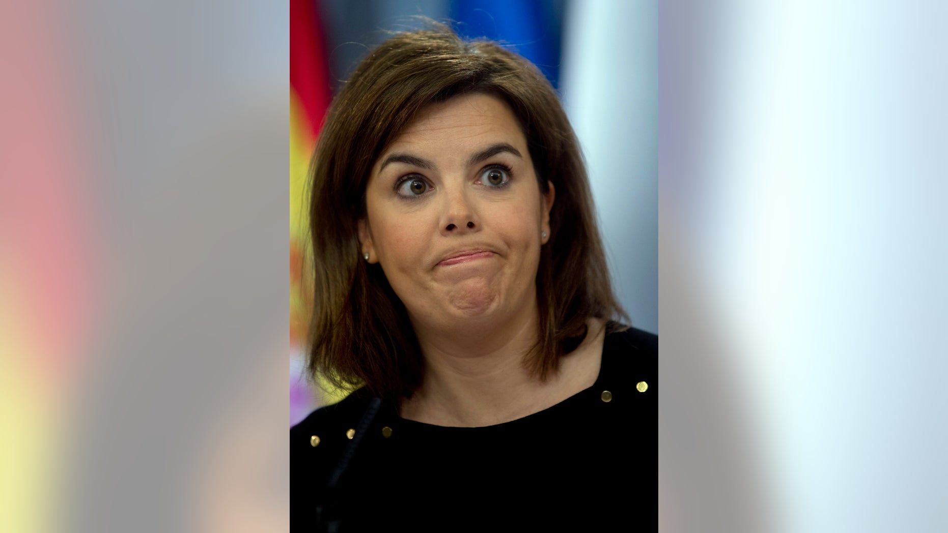 Spain's government spokeswoman and deputy premier Soraya Saenz de Santamaria reacts to a question during a news conference at the Moncloa Palace in Madrid, Friday Jan. 18, 2013. Spain's conservative government is battling to defend itself and its Popular Party after a court revealed a former party treasurer amassed euro 22 million ($29.31 million) in a Swiss bank account. Saenz de Santamaria fended off a barrage of questions from journalists Friday by denying she knew anything about the money or newspaper reports that ex-treasurer Luis Barcenas also gave party members large sums in under-the table payments. She skirted questions as to whether Prime Minister Mariano Rajoy or other government members may have received money. (AP Photo/Paul White)
