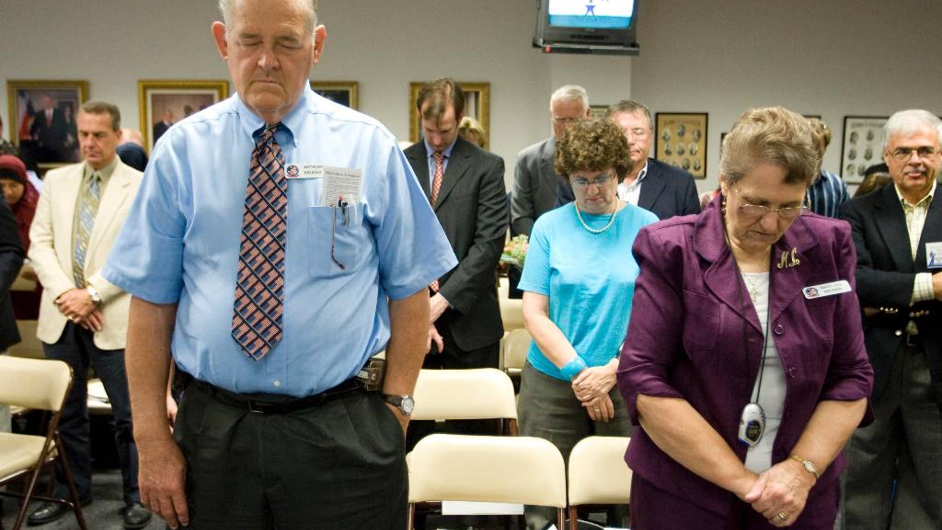 FILE - In this Sept. 24, 2010 file photo, Anthony Bruner and Mary Lou Bruner, right, pray at the start of a meeting of the Texas State Board of Education to discuss Islam and Christianity in textbooks in Austin, Texas. Mary Lou Bruner, a retired Texas schoolteacher who claims President Barack Obama is a gay prostitute is the Republican front-runner in a primary runoff for a seat on the influential state education board. Bruner is back on the ballot Tuesday, May 24, 2016, after nearly clinching the Republican nomination outright in March. (Jay Janner/Austin American-Statesman via AP, File) AUSTIN CHRONICLE OUT, COMMUNITY IMPACT OUT, INTERNET AND TV MUST CREDIT PHOTOGRAPHER AND STATESMAN.COM, MAGS OUT; MANDATORY CREDIT