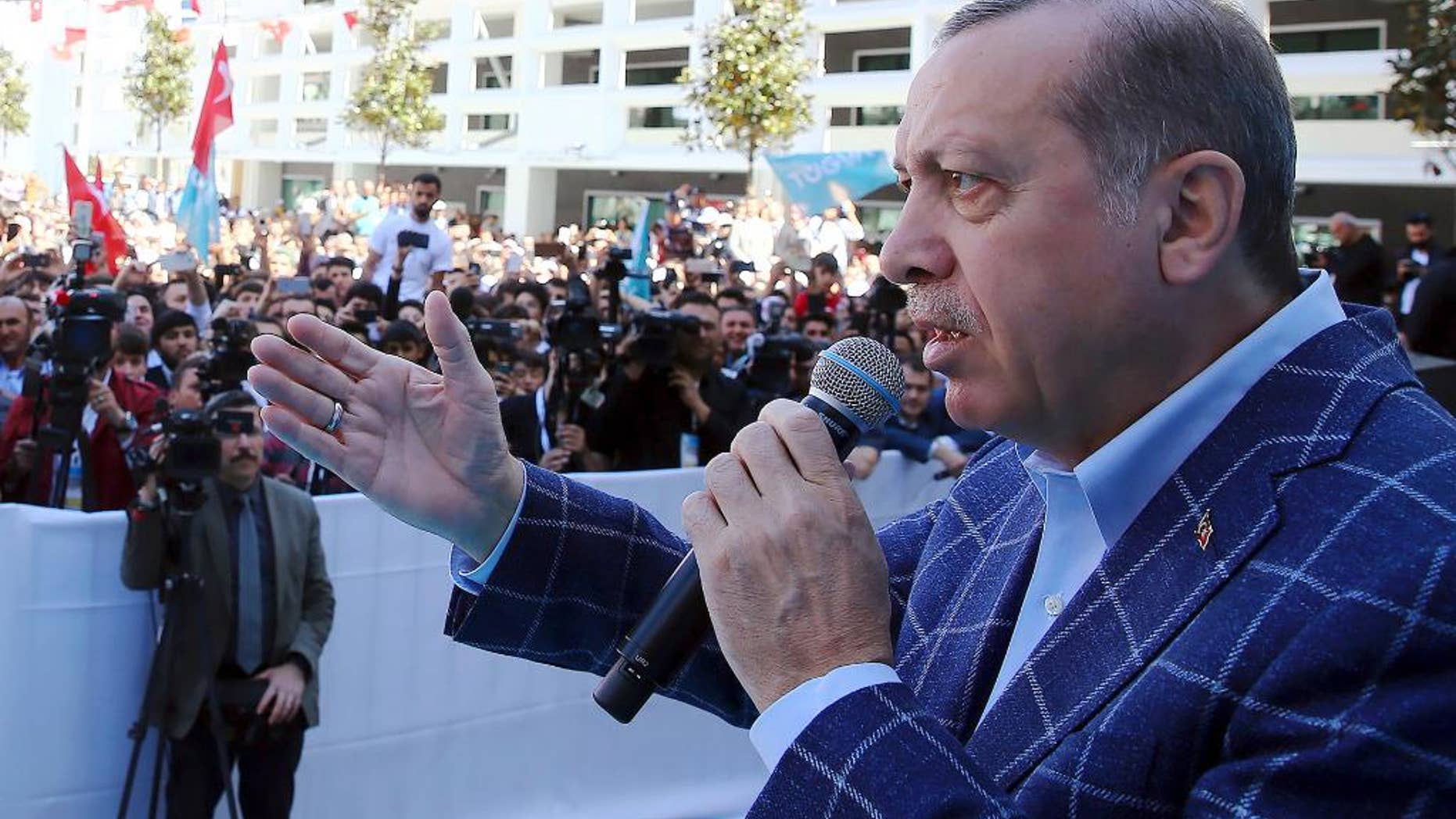 Turkey's President Recep Tayyip Erdogan addresses his supporters in Antalya, Turkey, Saturday, March 25, 2017. Erdogan on Friday has hit out at the head of Germany's intelligence service for comments suggesting that Berlin was not convinced over U.S.-based cleric Fethullah Gulen's role in Turkey's failed coup. Erdogan accused the BND foreign intelligence chief Bruno Kahl of making the remarks on behalf of Germany's leaders, whom he said backed Gulen's movement.(Kayhan Ozer/Presidential Press Service, Pool Photo via AP)