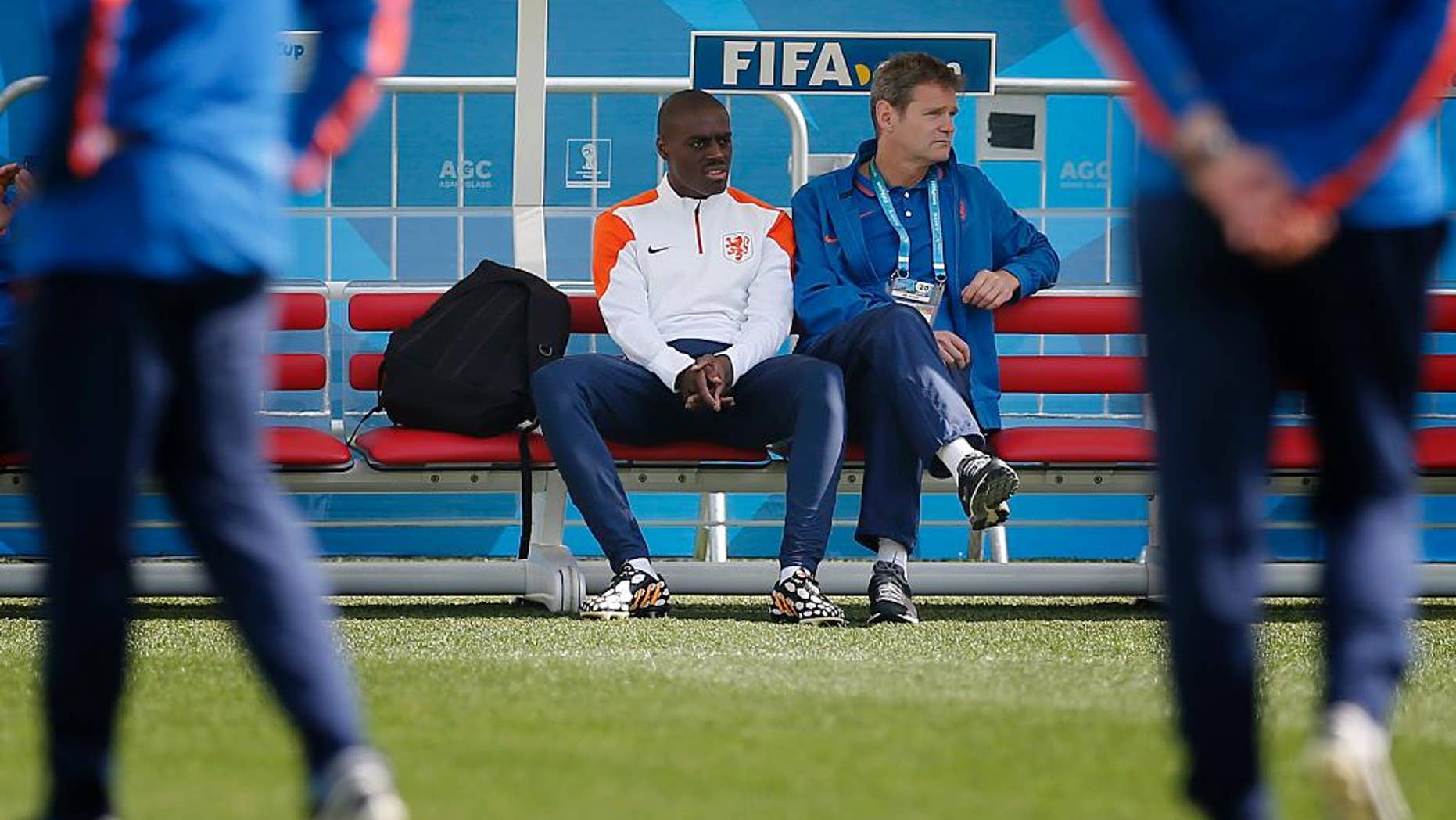 Bruno Martins Indi, left, of the Netherlands sits out of a training session at the Itaquerao Stadium in Sao Paulo, Brazil, Sunday, June 22, 2014. The Netherlands will play Chile in a match that will decide the winner of Group B at the 2014 soccer World Cup. (AP Photo/Wong Maye-E)