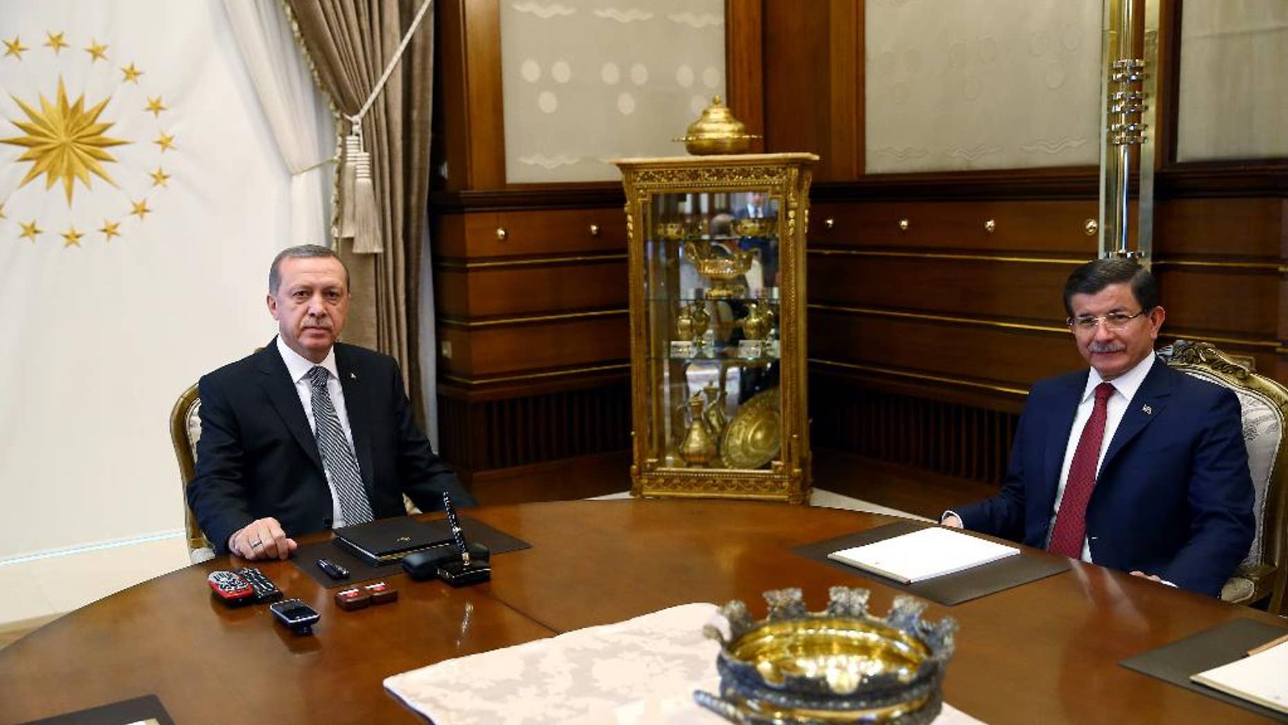 Turkish President Recep Tayyip Erdogan, left, and Prime Minister Ahmet Davutoglu attend a meeting at the presidential palace in Ankara, Turkey, Tuesday, Nov. 3, 2015. Turkish President Erdogan on Monday hailed a big victory for his ruling party in the country's parliamentary election and demanded the world respect the result.(AP Photo/Presidential Press Service, Pool)