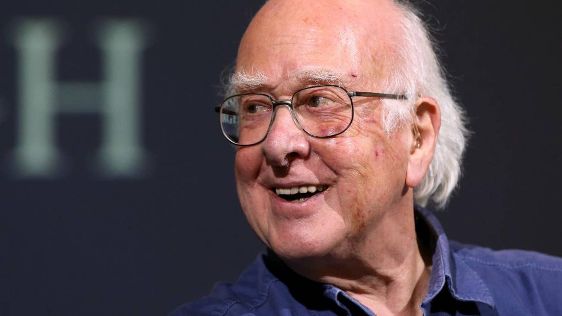 FILE - In this file photo dated Friday, Oct. 11, 2013, Britain's Professor Peter Higgs smiles during a press conference in Edinburgh, Scotland, Friday, Oct. 11, 2013. A group of 13 Nobel laureates, including Peter Higgs, have written an open letter published in a British national newspaper Saturday June 11, 2016, urging U.K. referendum voters to remain inside the European Union, warning that Britain will lose funding, global influence and access to expertise if the nation votes to leave the 28-nation bloc.(AP Photo/Scott Heppell, FILE)