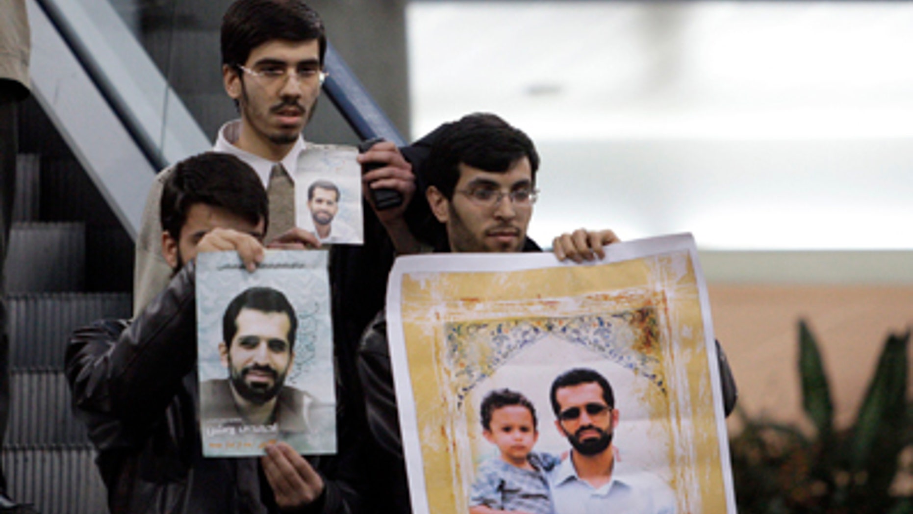 Jan. 29, 2012: An Iranian protester holds a placard against Israel and International Atomic Energy Organization, IAEA, at the Imam Khomeini airport, waiting for arrival of the agency's delegates, who were not appeared in public, as the others hold posters of Mostafa Ahmadi Roshan, a chemistry expert and director of the Natanz uranium enrichment facility in central Iran, who was killed in a bomb attack in Tehran earlier this month.