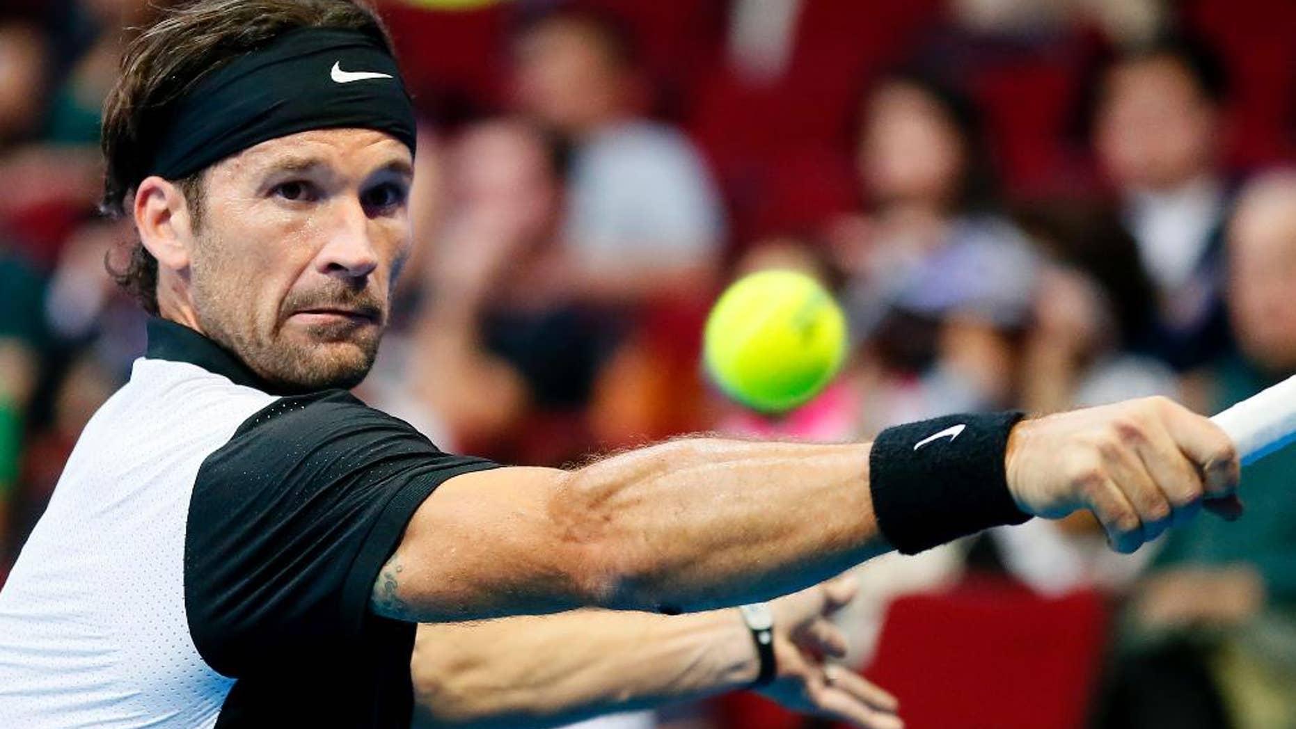 FILE - A Sunday, Dec. 6, 2015 photo from files of Carlos Moya returning a shot to opponent Marat Safin during the Manila leg of the 2015 International Premier Tennis League (IPTL) at the Mall of Asia Arena at suburban Pasay city south of Manila, Philippines. Rafael Nadal has added former player Carlos Moya to his team for the 2017 season. Nadal said in Saturday’s announcement that Moya will work together with Toni Nadal and Francis Roig. (AP Photo/Bullit Marquez, File)