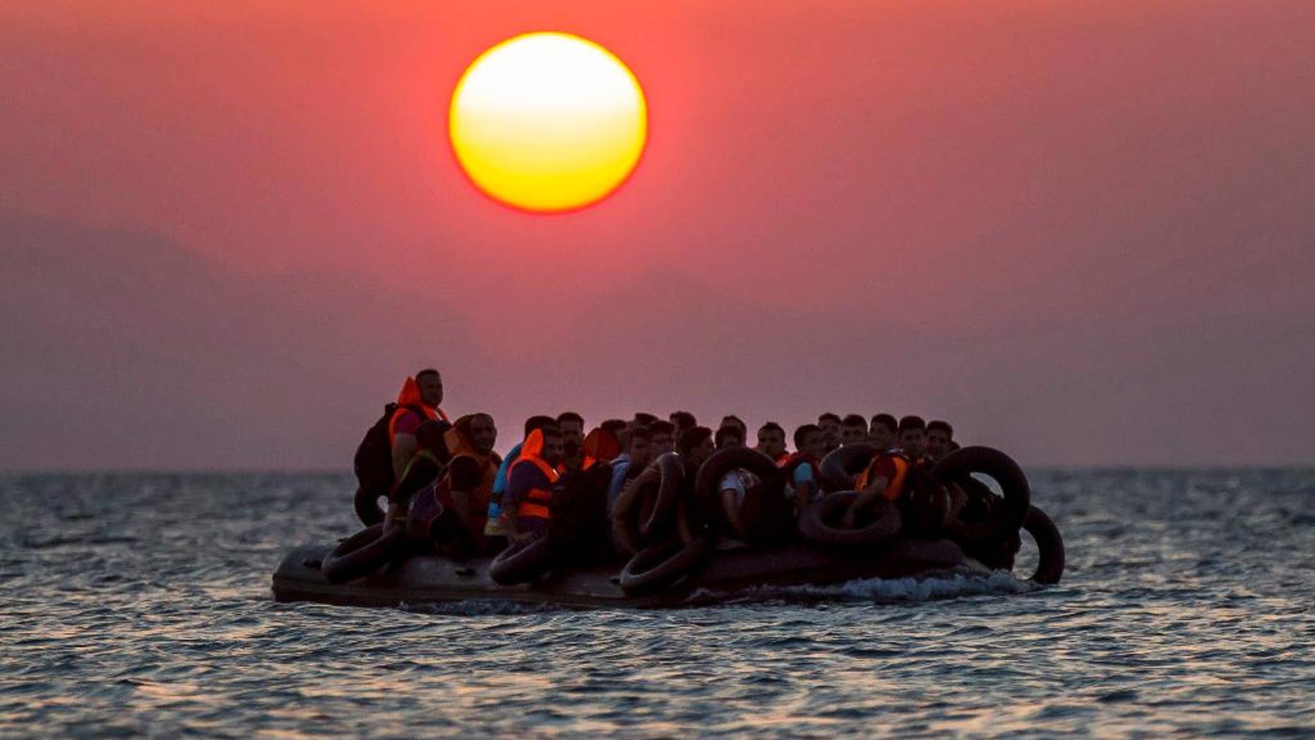 Refugeess on a dinghy approach the southeastern island of Kos, Greece, in August 2015.