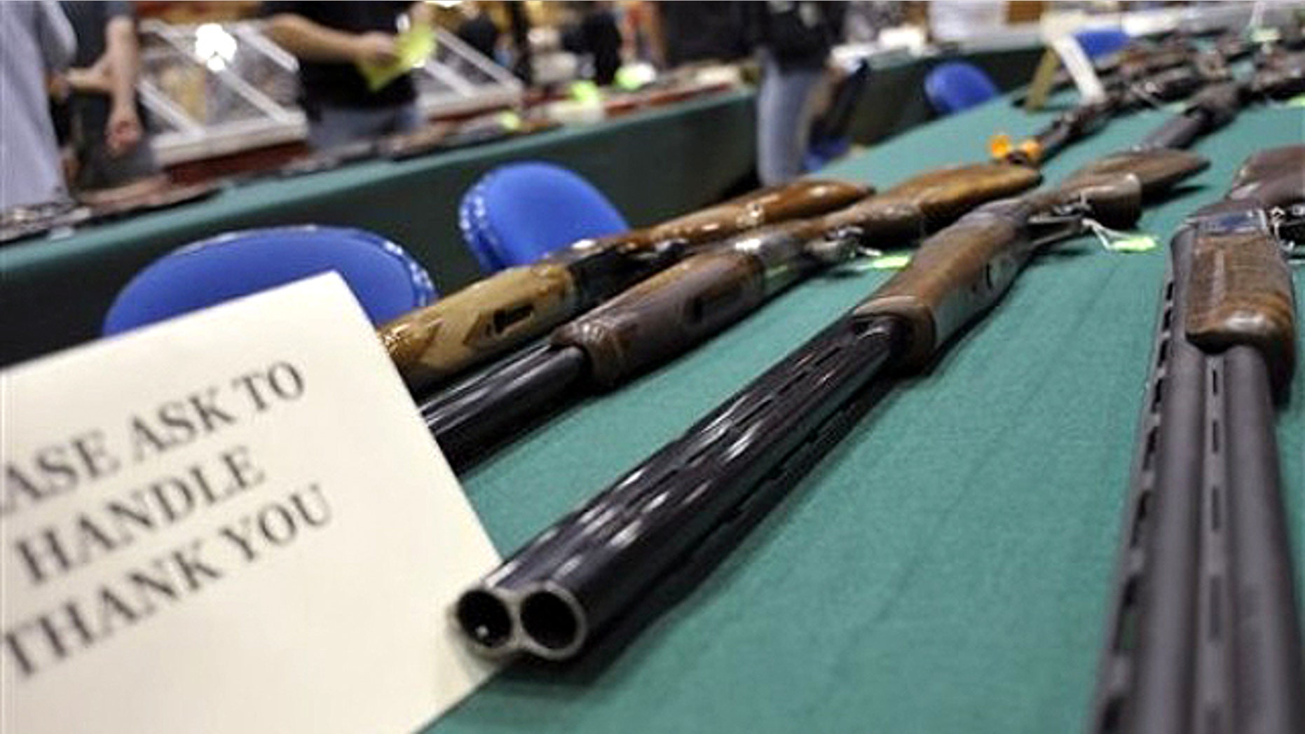 File: June 19, 2010: Assorted shotguns are displayed on a table at a gun and knife show in White Plains, N.Y.,