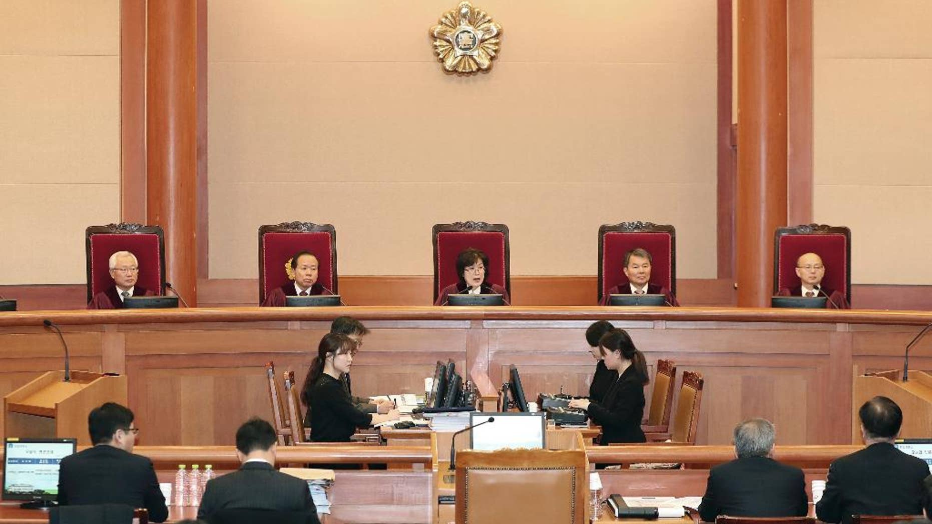 Judges of the Constitutional Court sit during a hearing on whether to confirm the impeachment of President Park Geun-hye, at the Court in Seoul, South Korea, Thursday, Feb. 9, 2017. Prosecutors say South Korea's impeached president has canceled plans to undergo questioning to protest leaks to the media about her investigation. (Kim Hyun-tae/Yonhap via AP)