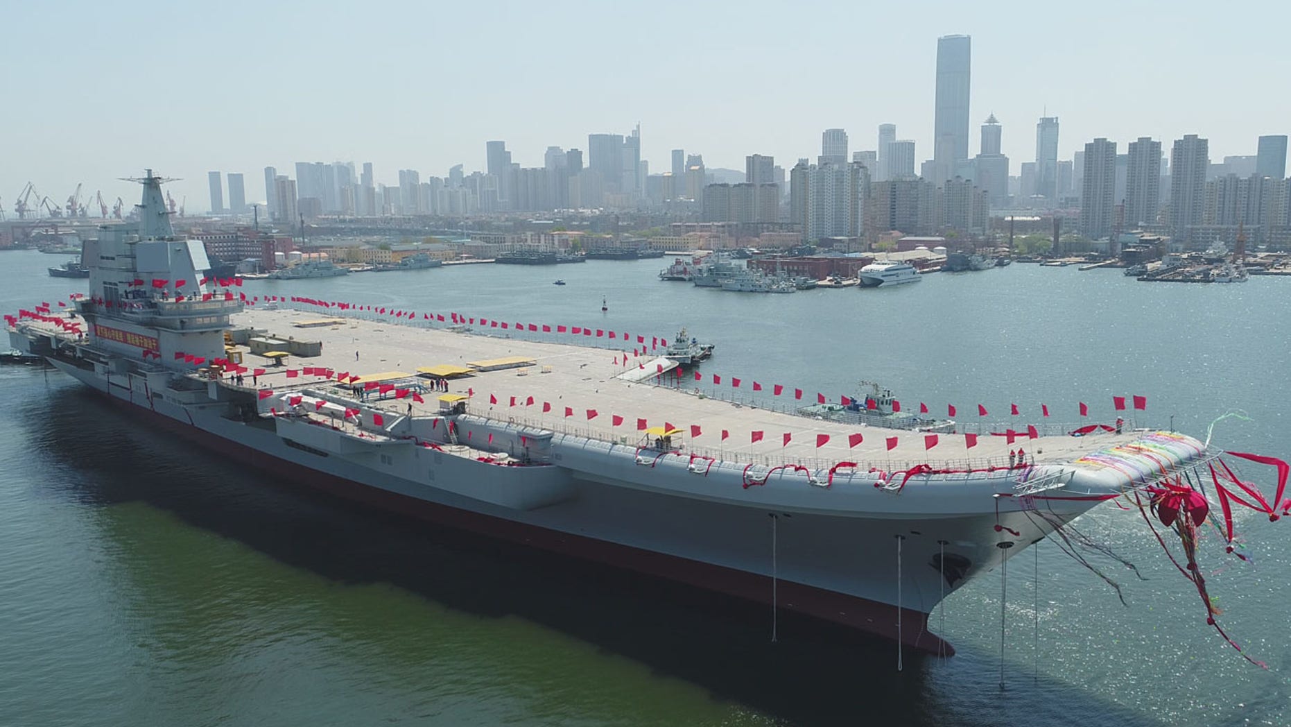 In this photo released by China's Xinhua News Agency, a newly-built aircraft carrier is transferred from dry dock into the water at a launch ceremony at a shipyard in Dalian in northeastern China's Liaoning Province, Wednesday, April 26, 2017.