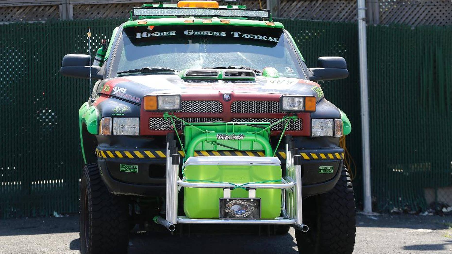 A vehicle belonging to a group of people arrested on weapon charges sits in the Port Authority Police Department impound lot a day after the group was stopped prior to entering the Holland Tunnel, Wednesday, June 22, 2016, in Jersey City, N.J. (AP Photo/Julio Cortez)