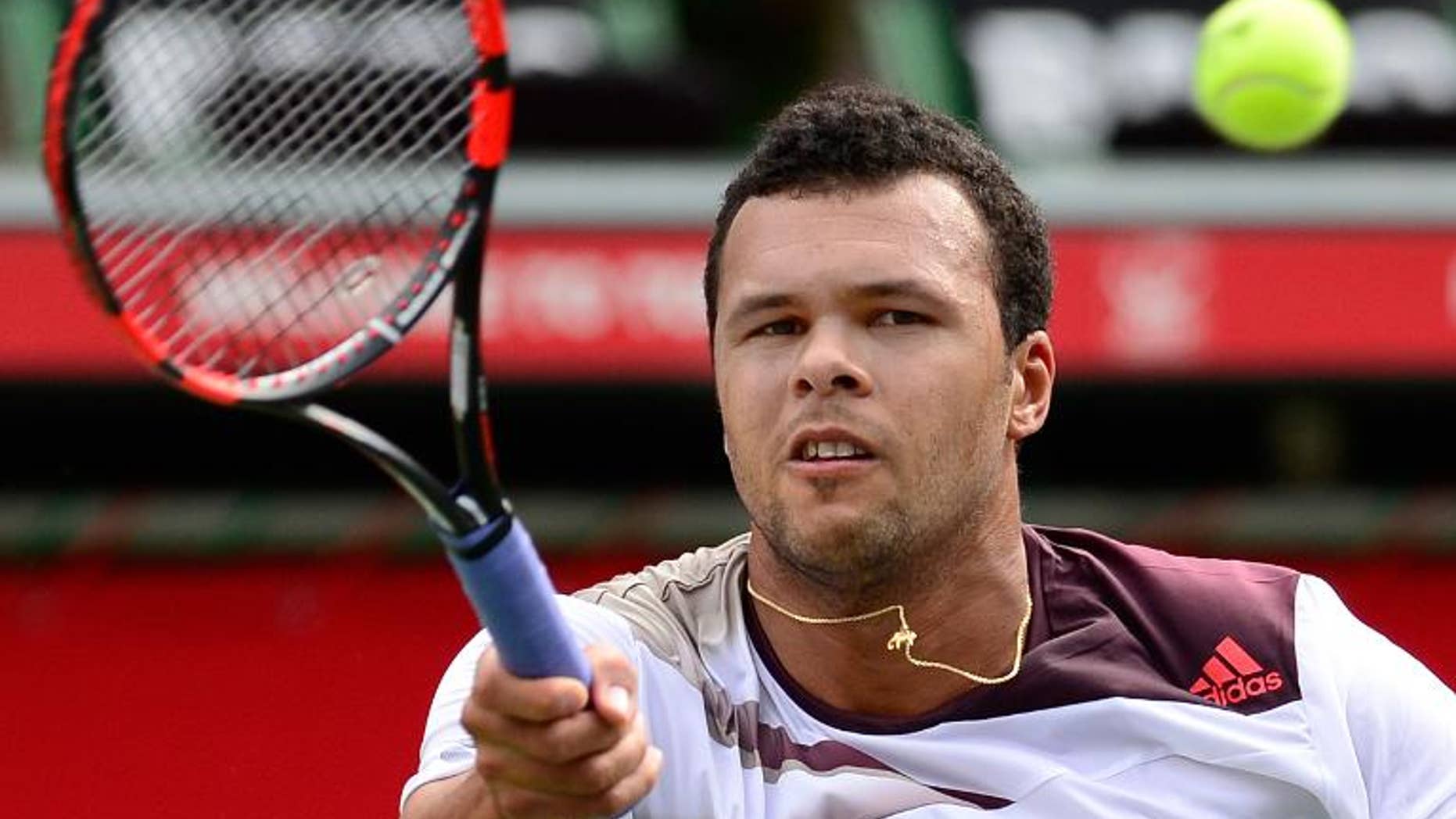 France's Jo-Wilfried Tsonga hits a return against his compatriot Gael Monfils during their first round match Japan Open first round in Tokyo on September 30, 2013. Tsonga defeated Monfils 6-3, 7-6 (10/8).