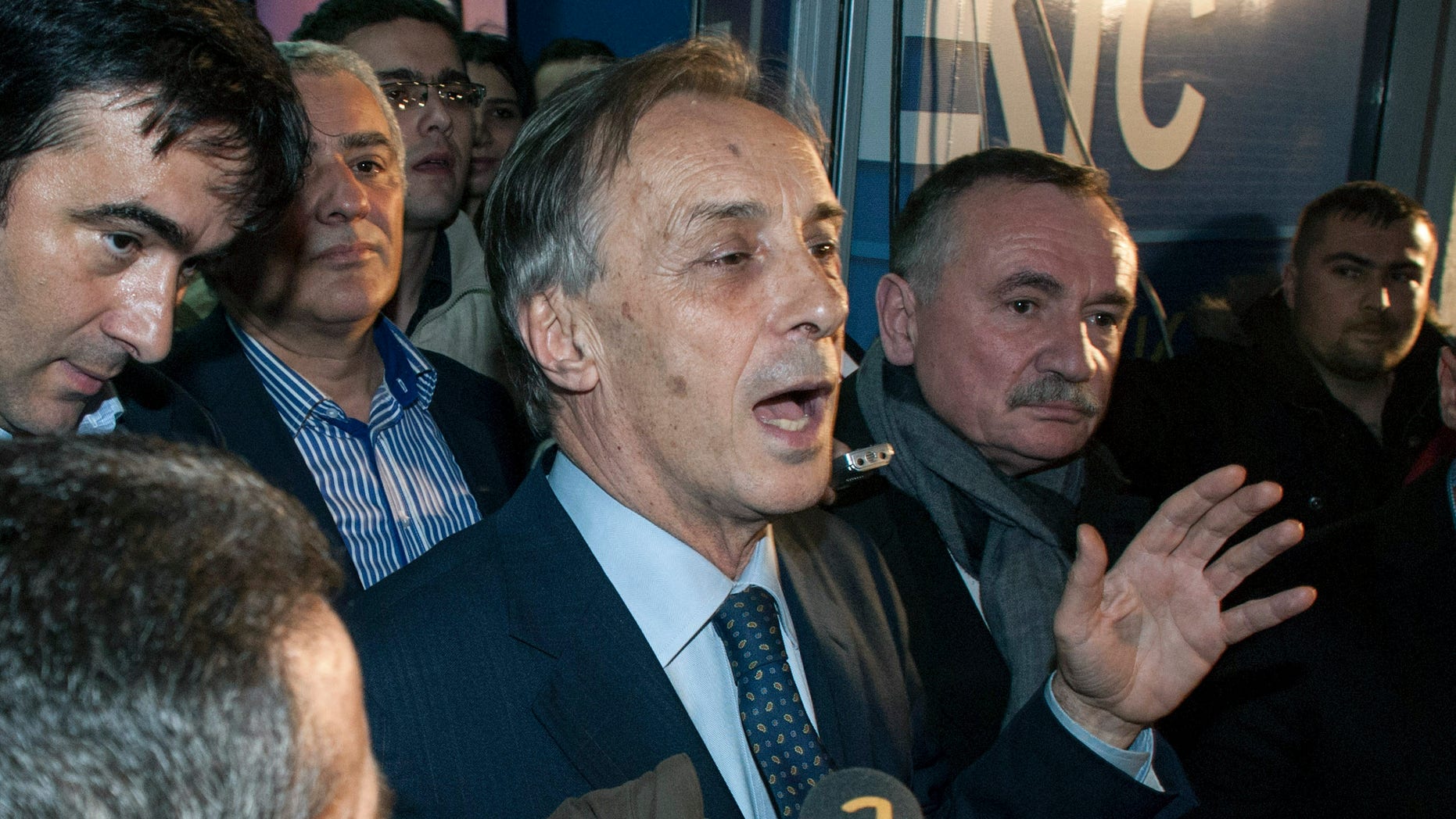 Presidential candidate Miodrag Lekic addresses his supporters after his headquarters claimed victory in Podgorica, Montenegro, Sunday, April 7, 2013. Both the incumbent and the opposition candidate claimed victory in Montenegro's presidential election on Sunday, fueling political tensions in the small Balkan country which is striving for European Union membership. State election authorities had yet to release any official results in the race for the largely ceremonial post. President Filip Vujanovic, from the ruling Democratic Party of Socialists, said that based on his camp's own, full count of the votes, he had won 51.3 percent of ballots, while opponent Lekic won 48.7 percent. (AP Photo/Risto Bozovic)