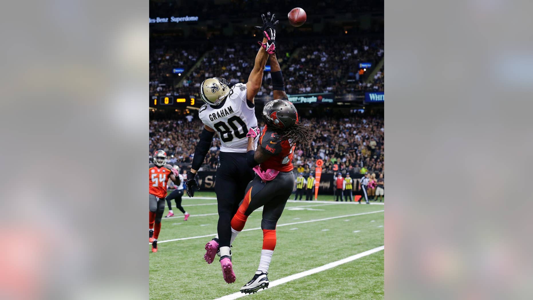 New Orleans Saints tight end Jimmy Graham (80) leaps for an overthrown pass as Tampa Bay Buccaneers strong safety Mark Barron defends in the first half of an NFL football game in New Orleans, Sunday, Oct. 5, 2014. (AP Photo/Bill Haber)