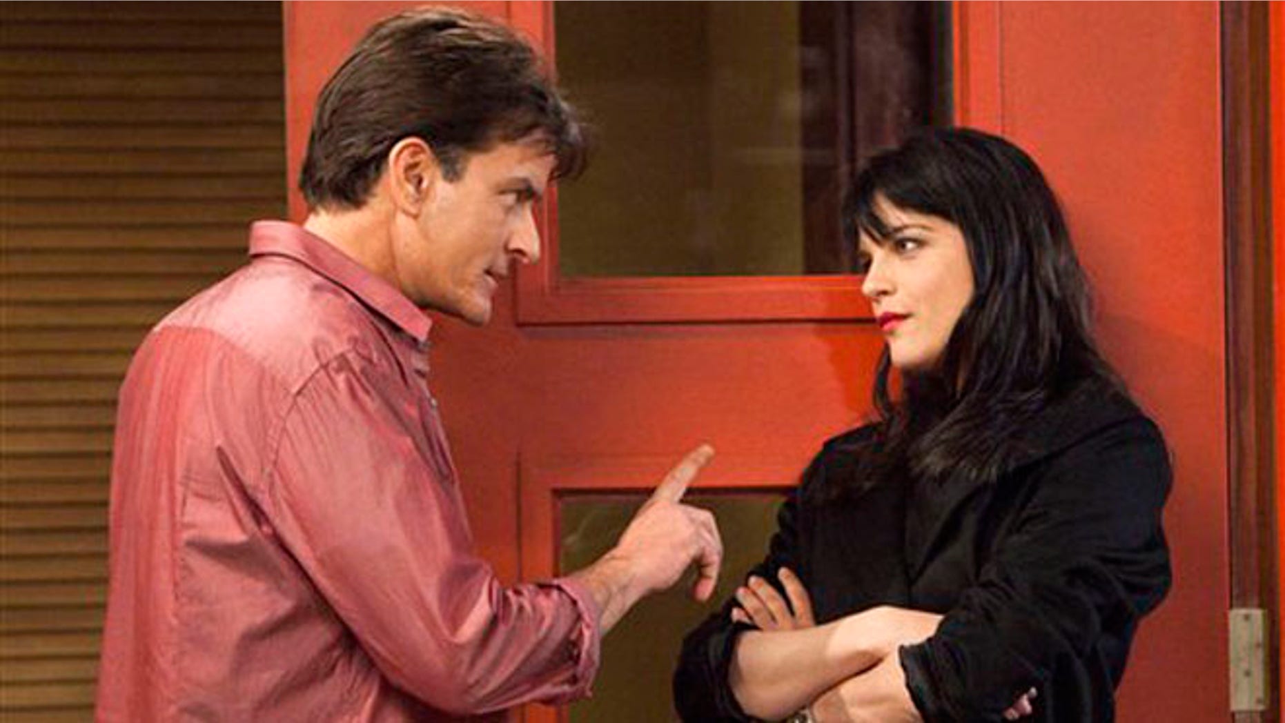 This file publicity image provided by FX shows Charlie Sheen as Charlie Goodson and Selma Blair as Kate Wales in a scene from the new comedy "Anger Management."