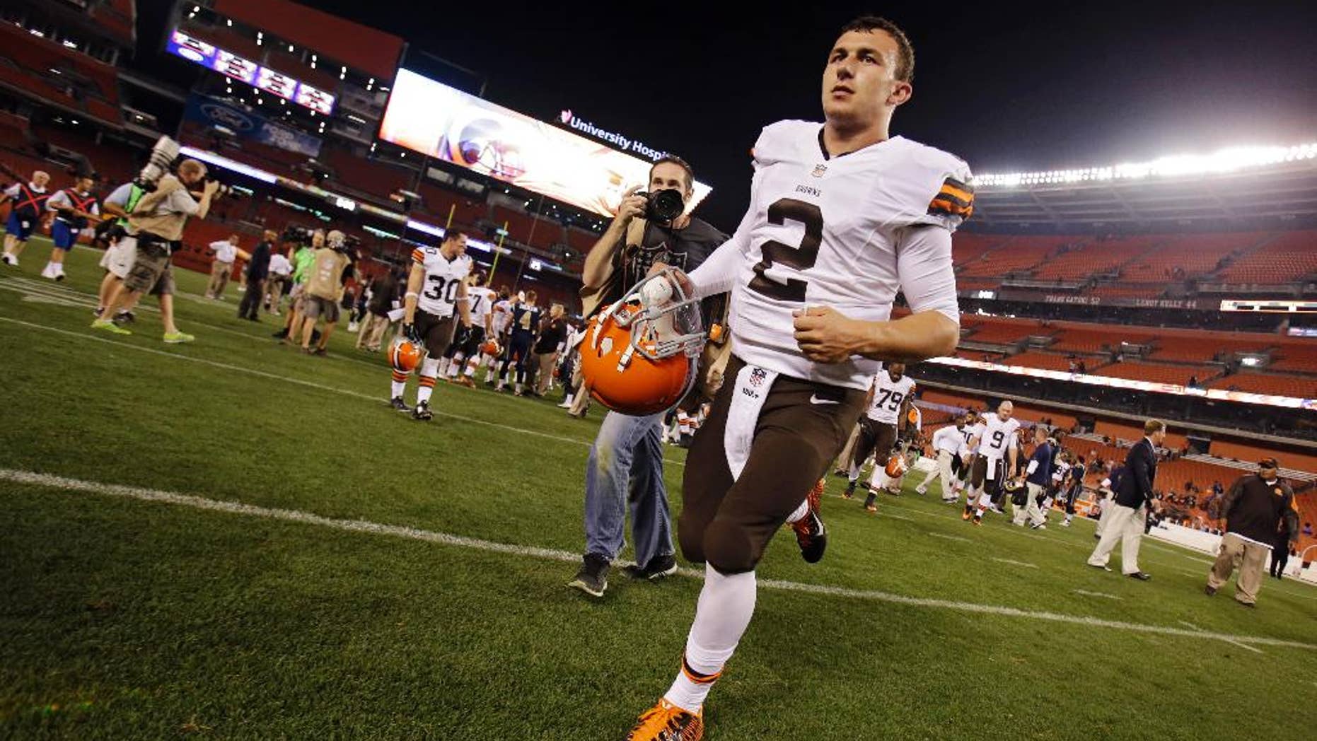 Cleveland Browns quarterback Johnny Manziel (2) runs off the field after a 33-14 loss to the St. Louis Rams in a preseason NFL football game Saturday, Aug. 23, 2014, in Cleveland. (AP Photo/Tony Dejak)