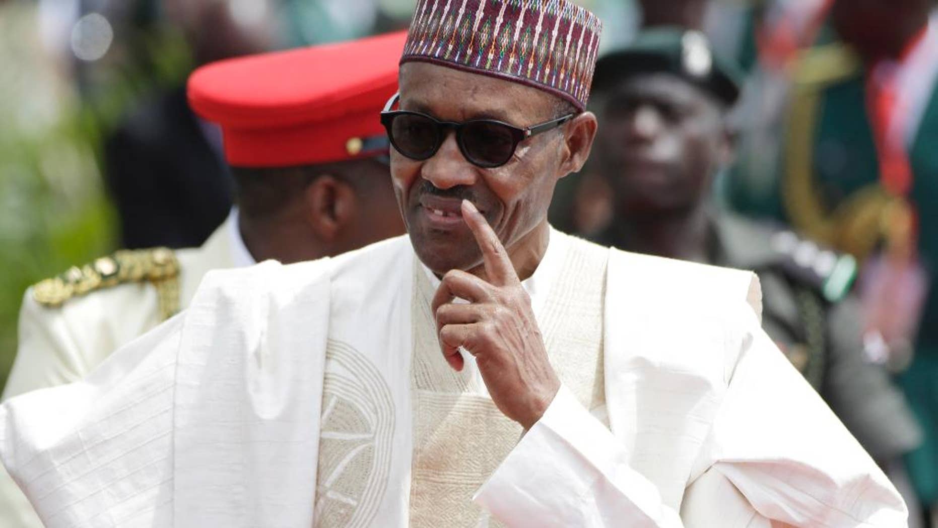 FILE- In this file photo taken Friday, May 29, 2015, former General and Nigerian President, Muhammadu Buhari, arrives for his Inauguration at the eagle square in Abuja, Nigeria. Nigeria’s new President Muhammadu Buhari makes his first official visit to one-time enemy Cameroon on Wednesday, July 29, 2015 to ease tensions and bolster support for a regional army to fight the Boko Haram Islamic uprising that is spilling across borders, his spokesman and Cameroon’s defense minister said. (AP Photo/Sunday Alamba, File)
